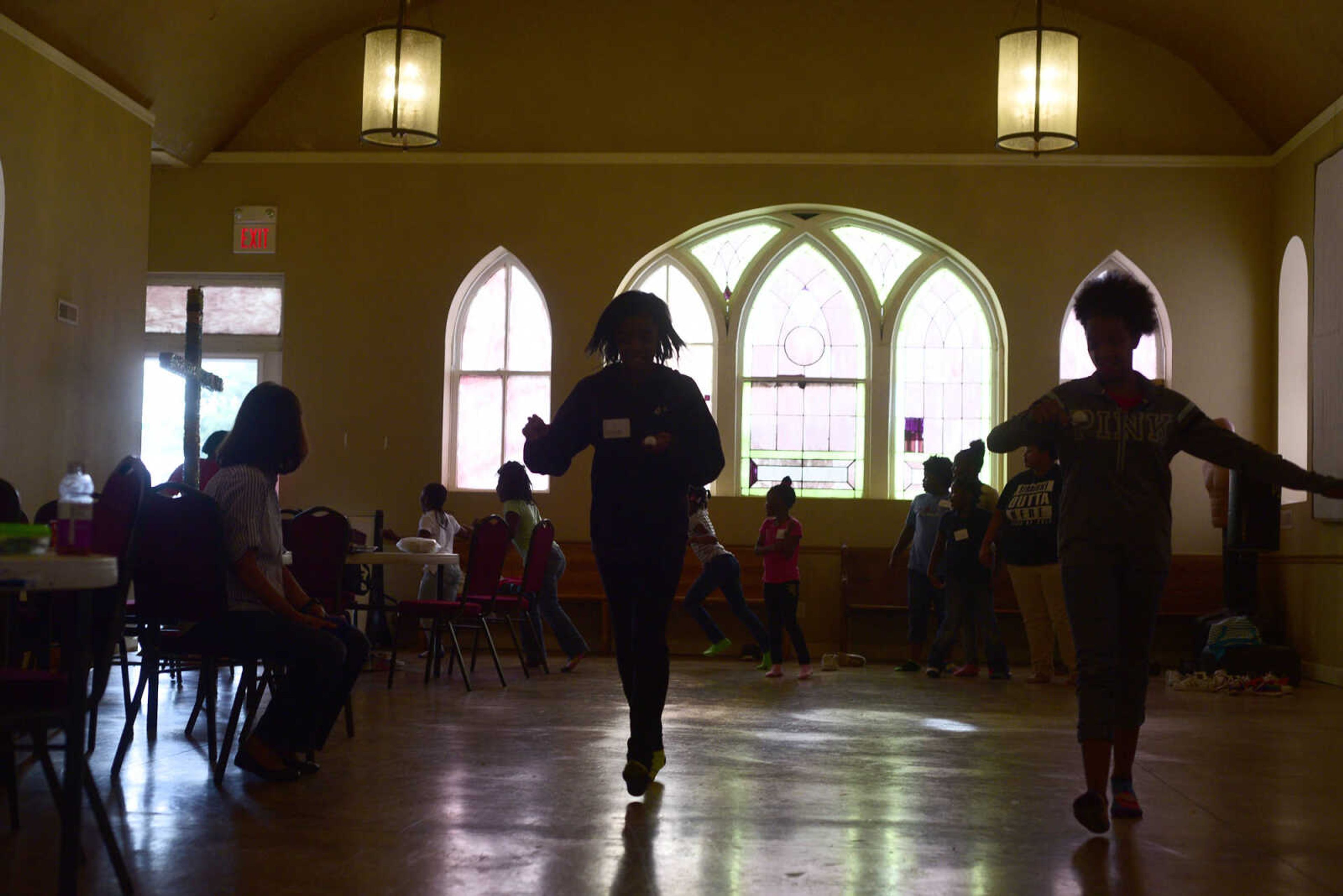 Students try to carry a ping pong ball on a spoon without dropping it on Monday, Aug. 14, 2017, during the Salvation Army's after school program at The Bridge Outreach Center in Cape Girardeau.