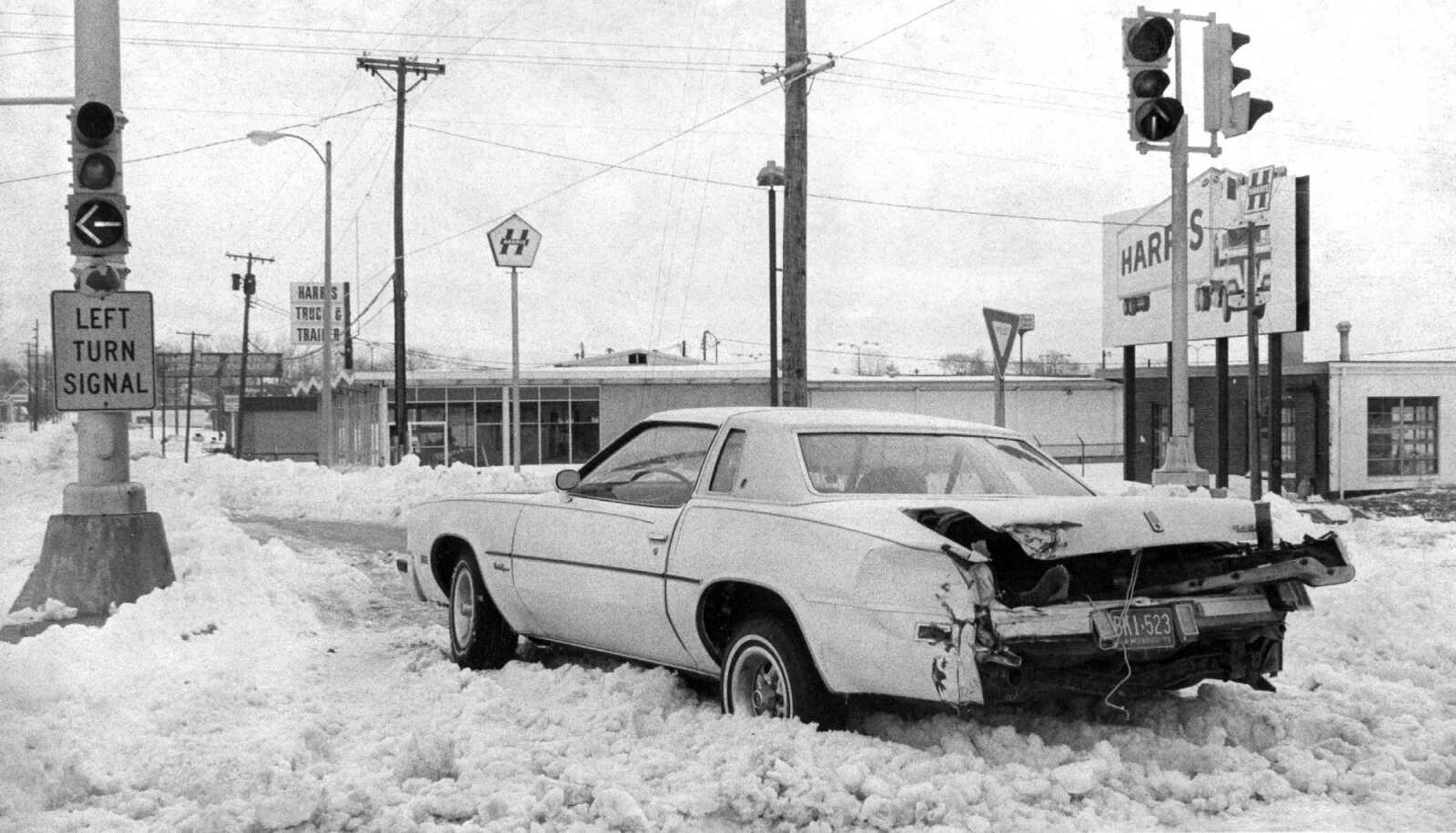 Travel in passenger cars was discouraged, to say the least, by authorities and the picture here illustrates the reason. The car either was stalled and was hit or was hit and then abandoned at the intersection of Kingshighway and Independence Street. Whatever the sequence of events, the car sat in the middle of a key intersection. (Southeast Missourian archive photo by Fred Lynch)