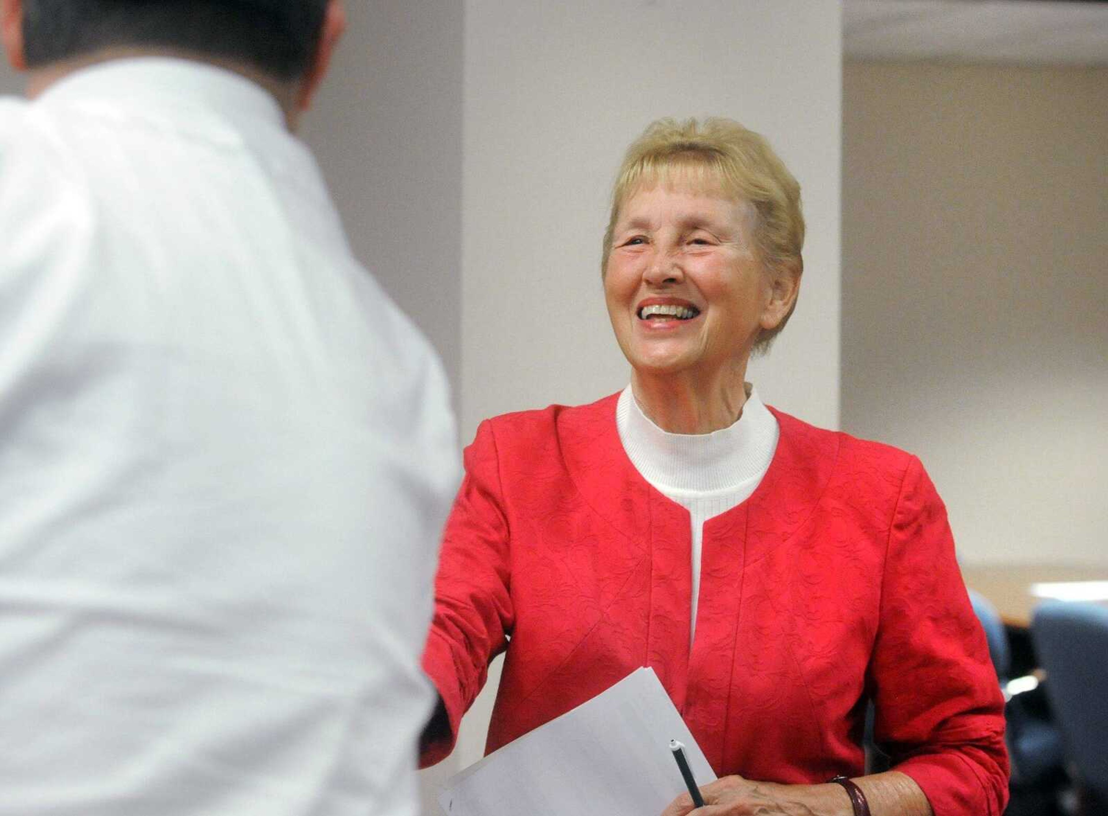 Former Jackson mayor Barbara Lohr shakes hands with people after beginning the Board of Aldermen meeting, Monday at Jackson City Hall. Dwain Hahs, who defeated Lohr in April's election, was sworn in as the new mayor Monday night. (Laura Simon)