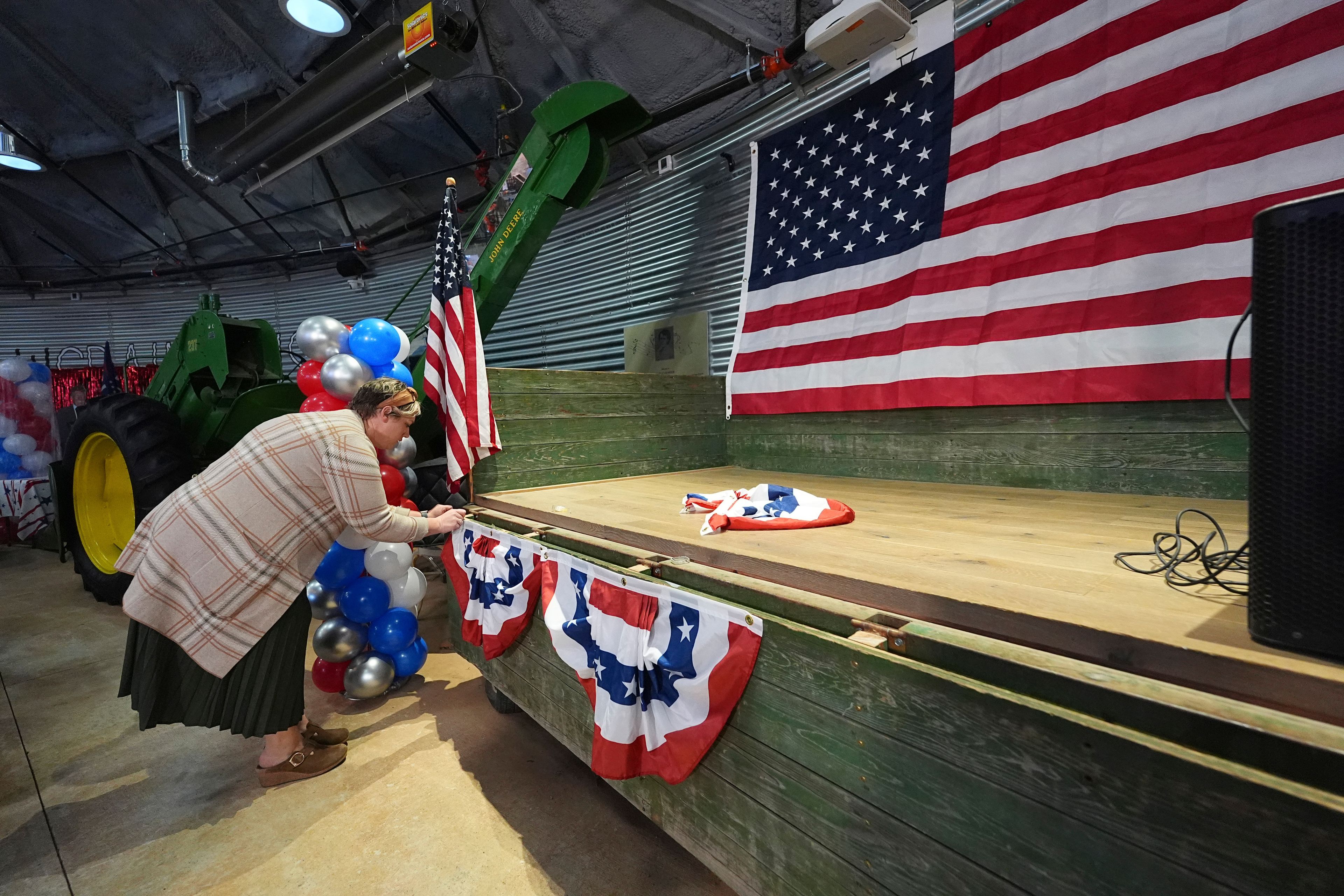 Alysa Balfour of Loveland, Colo., decorates the stage at the watch party for Lauren Boebert, Republican candidate for Colorado's 4th Congressional District, Tuesday, Nov. 5, 2024, in Windsor, Colo. (AP Photo/David Zalubowski)