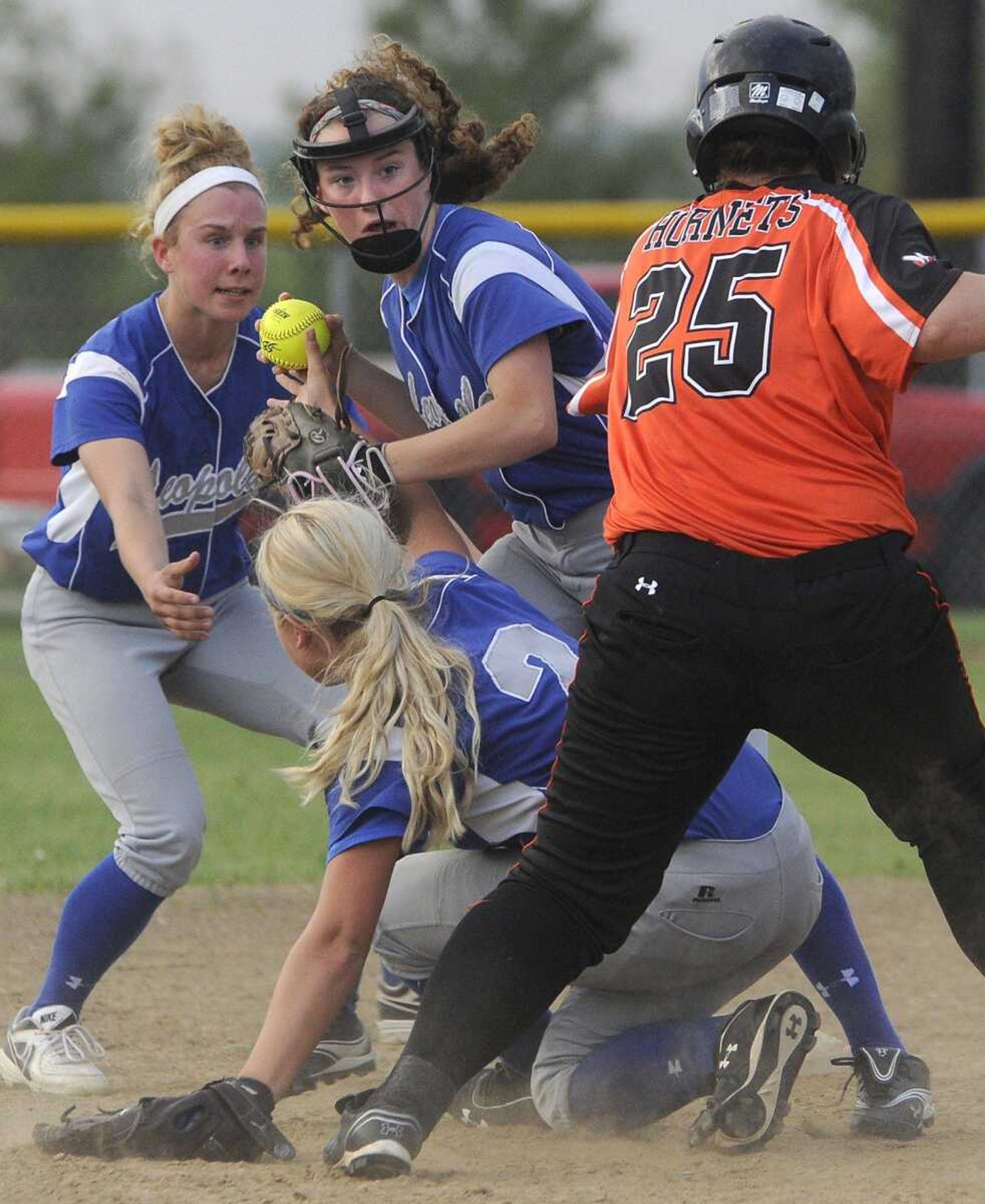 Leopold shortstop Shelby Schreckenberg catches Advance baserunner Haleah Wallace off second base for a double out after catching an Advance popup to end the game 15-1 during the fifth inning of a semifinal game of the Class 1 District 4 softball tournament Tuesday, May 5, 2015 in Scott City. Leopold center fielder Leah Landewee, left, looks on as third baseman Klara Beel covers the base. (Fred Lynch)