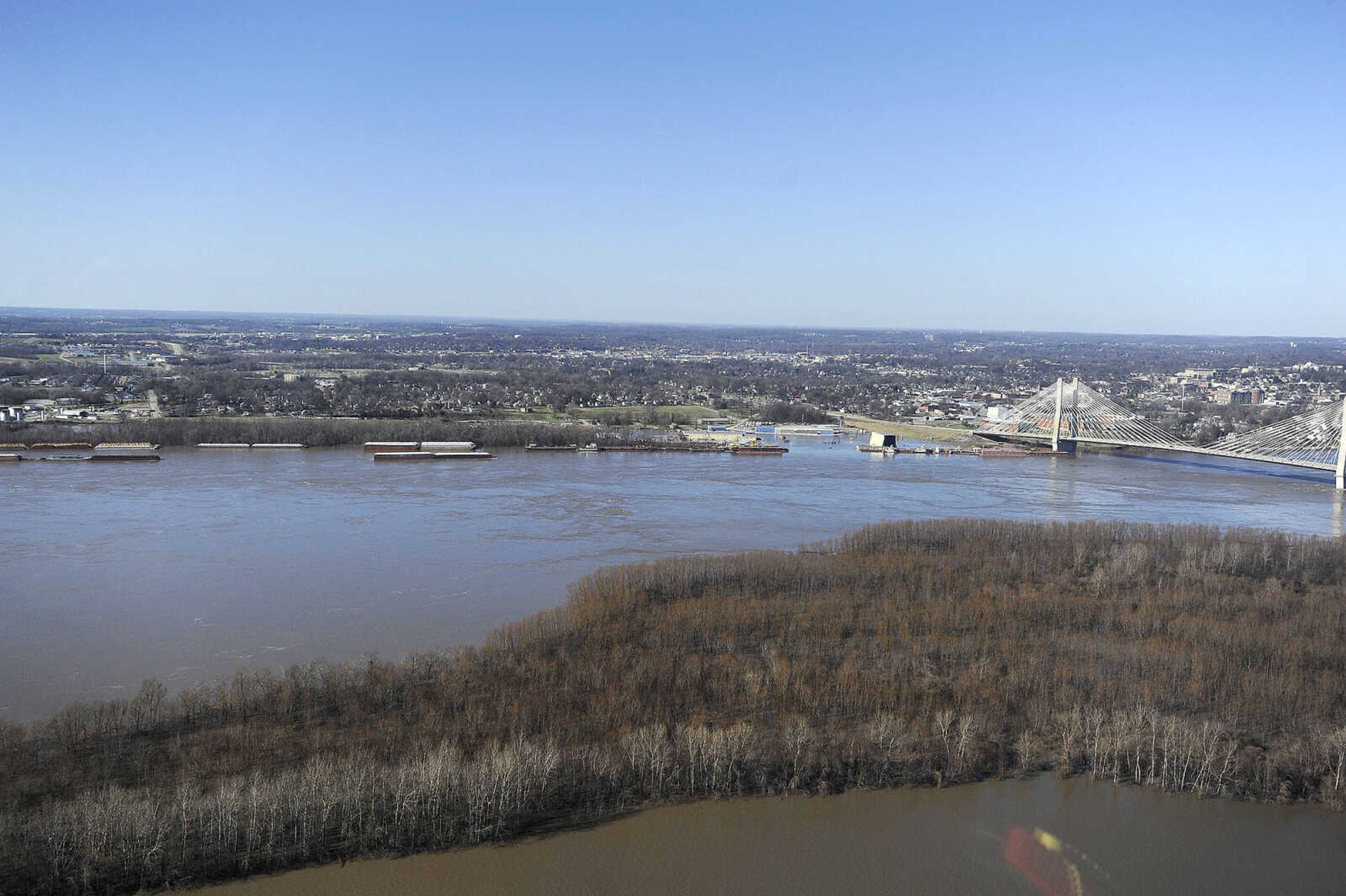 LAURA SIMON ~ lsimon@semissourian.com

The swollen Mississippi River is seen flowing under the Bill Emerson Memorial Bridge in Cape Girardeau, Saturday, Jan. 2, 2016.