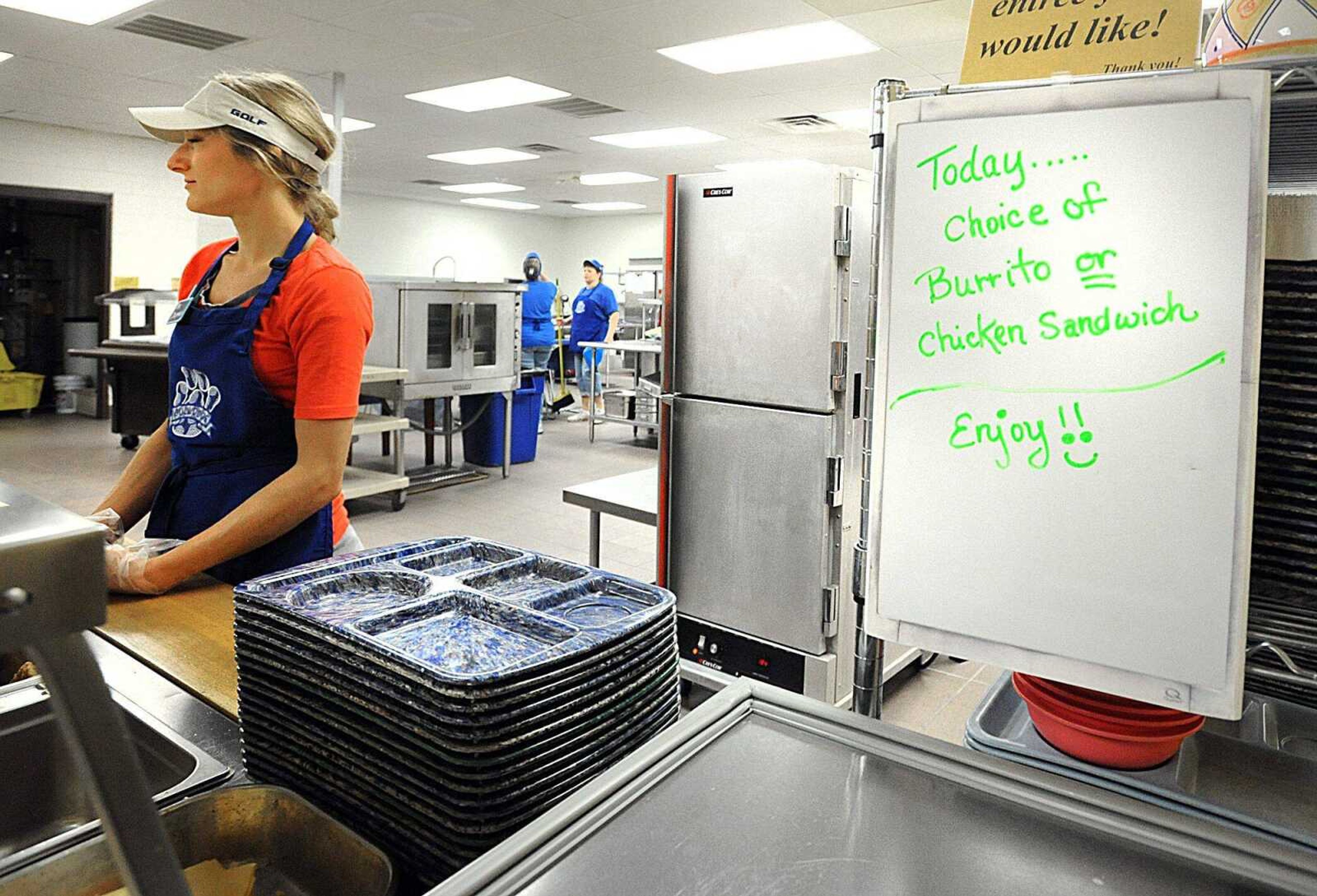 Alyssa Chapman waits for students to come through the lunch line at Notre Dame Regional High School. (Laura Simon)