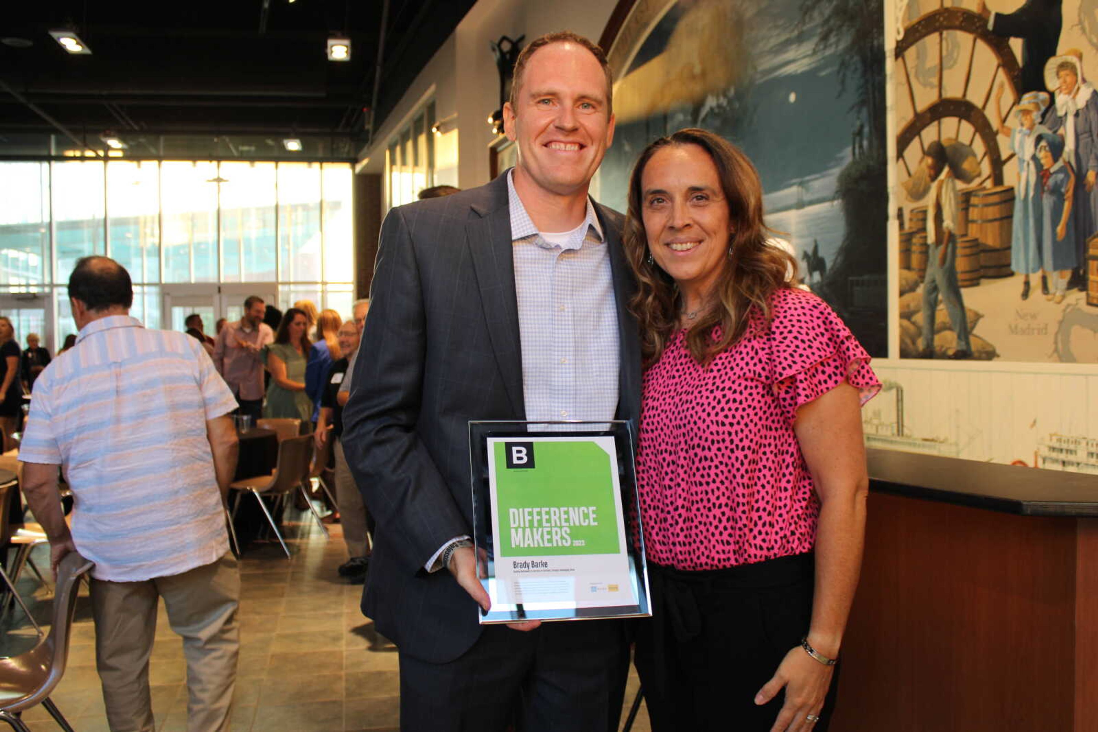 Brady Barke and his wife Halley Barke pose with his Difference maker award after the ceremony.&nbsp;