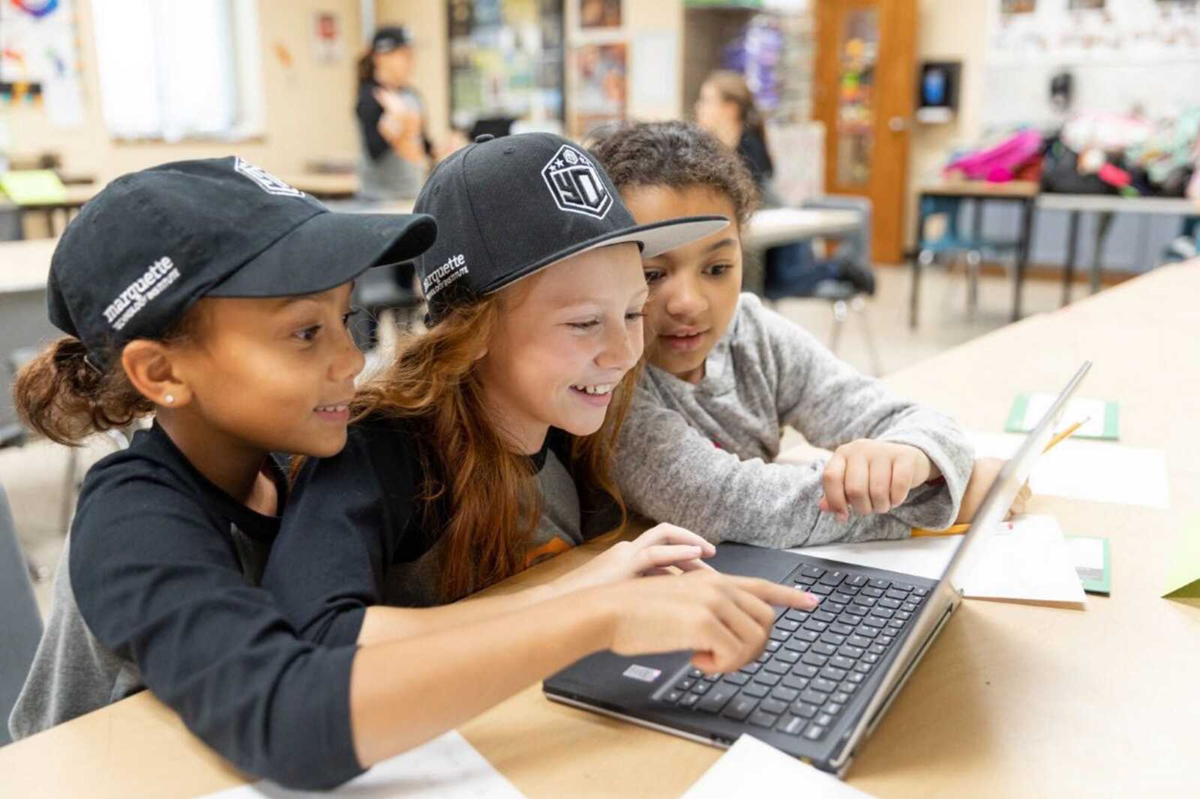 Youth Coding League players assemble code on laptops Sept. 25.