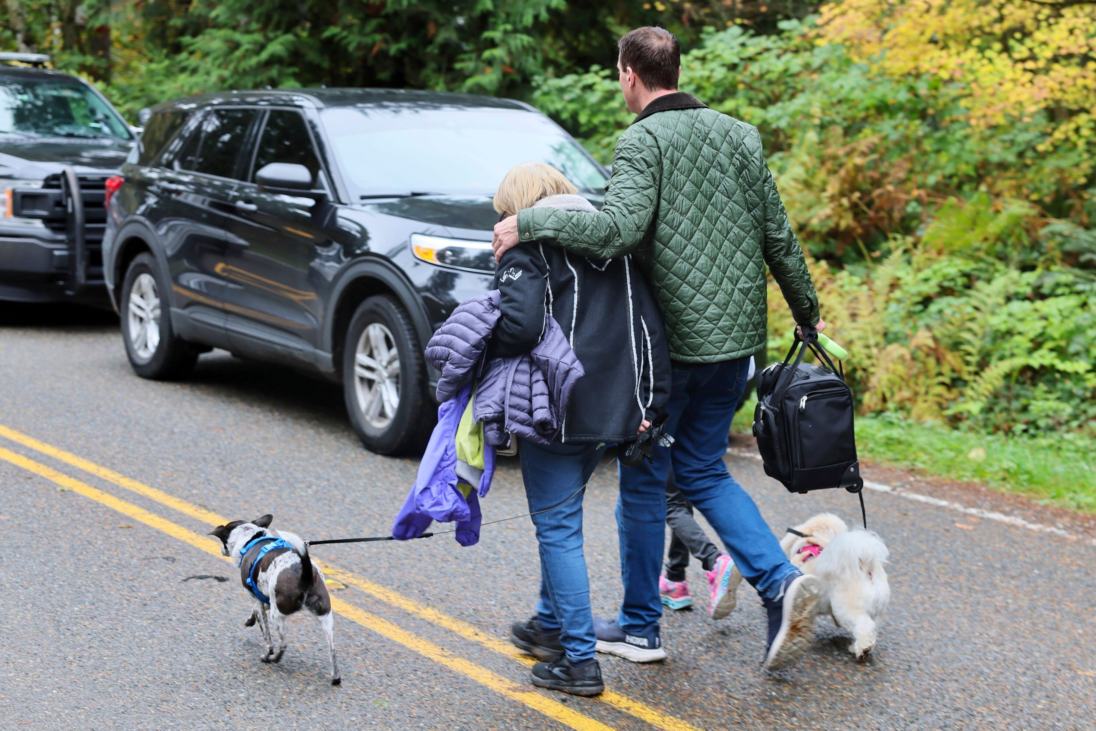 Neighbors leave the scene of a fatal shooting Monday morning, Oct. 21, 2024, in Fall City, Wash. (Kevin Clark/The Seattle Times via AP)