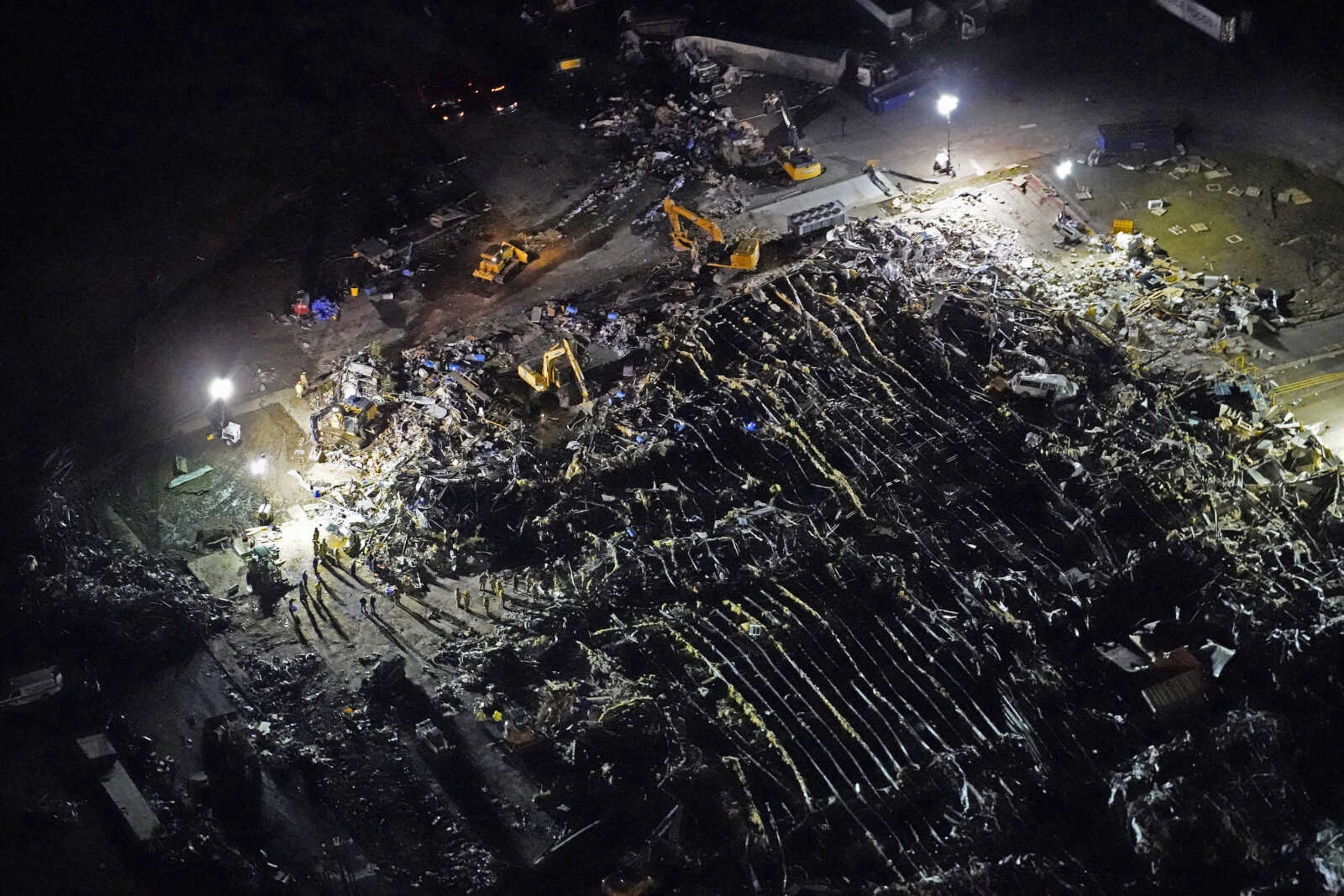 In this aerial photo, a collapsed factory is seen with workers searching for survivors, after tornadoes came through the area the previous night, in Mayfield, Ky., Saturday, Dec. 11, 2021. (AP Photo/Gerald Herbert)