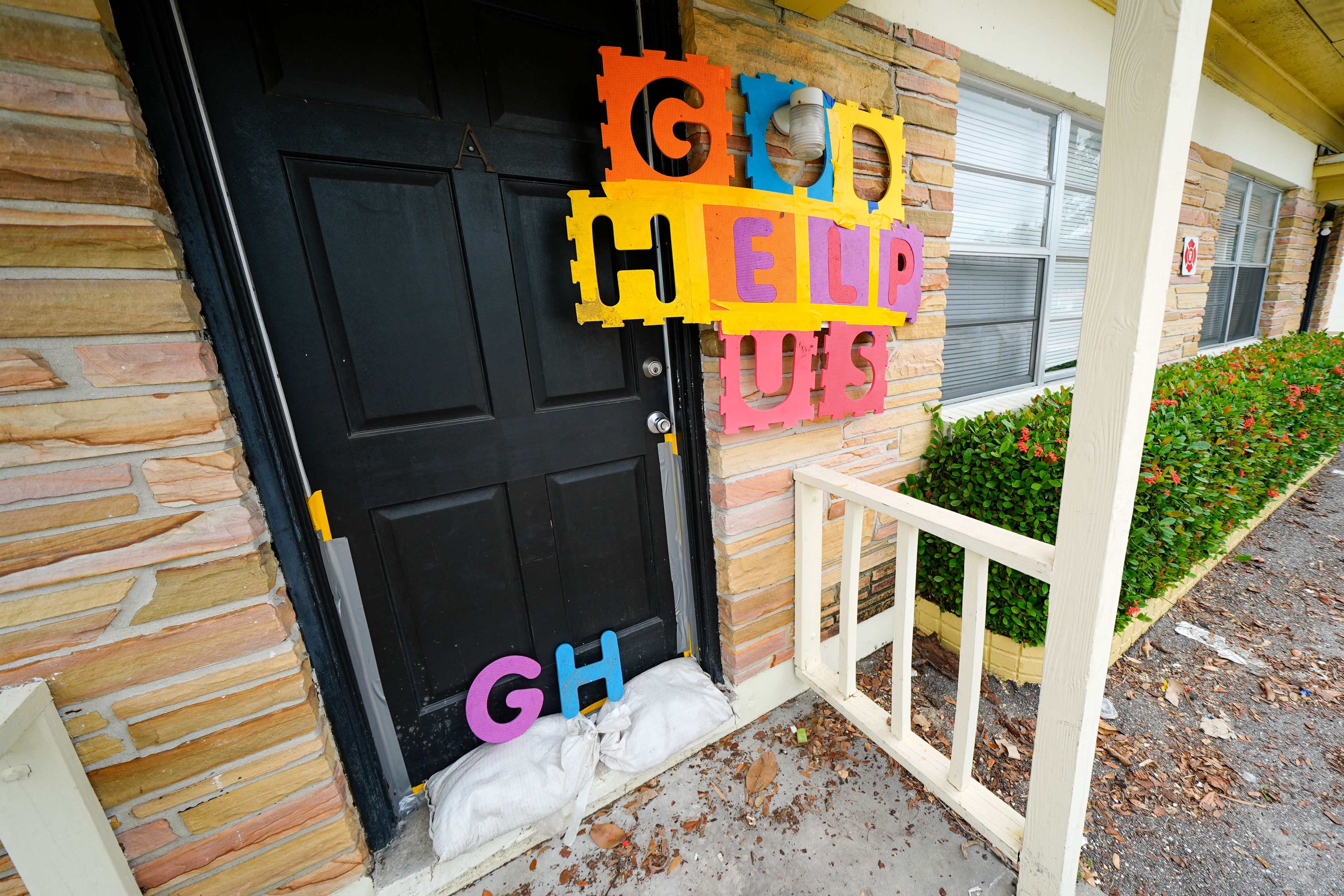 A message is seen outside of an apartment in the Davis Islands community of Tampa, Fla., as residents prepare for the arrival of Hurricane Milton, Tuesday, Oct. 8, 2024. (AP Photo/Julio Cortez)