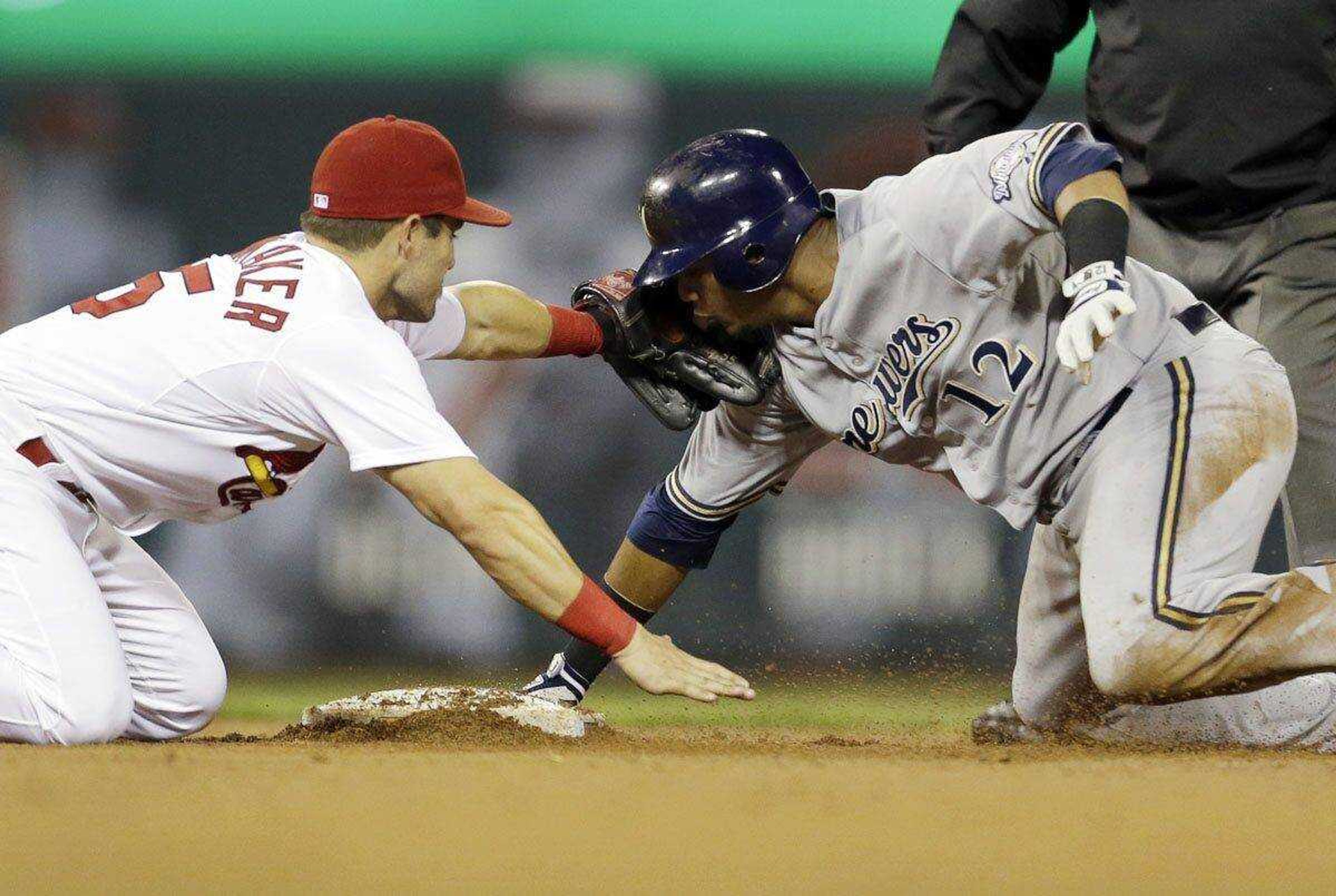 Brewers&#8217; Martin Maldonado, right, is tagged out by Cardinals second baseman Skip Schumaker while trying to stretch a single into a double during the eighth inning Saturday in St. Louis. (Jeff Roberson ~ Associated Press)