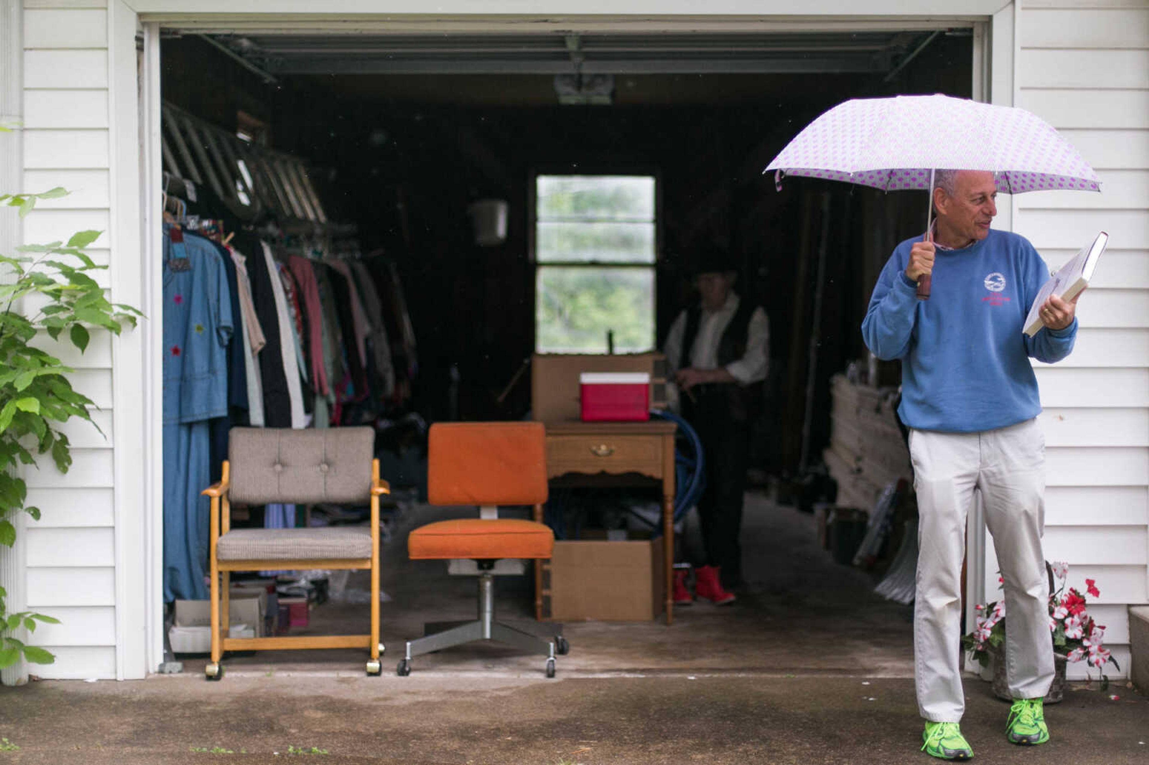 Dr. Mitch Gerber looks over a book he purchased from an estate sale Saturday, May 16, 2015 in Cape Girardeau. (Glenn Landberg)