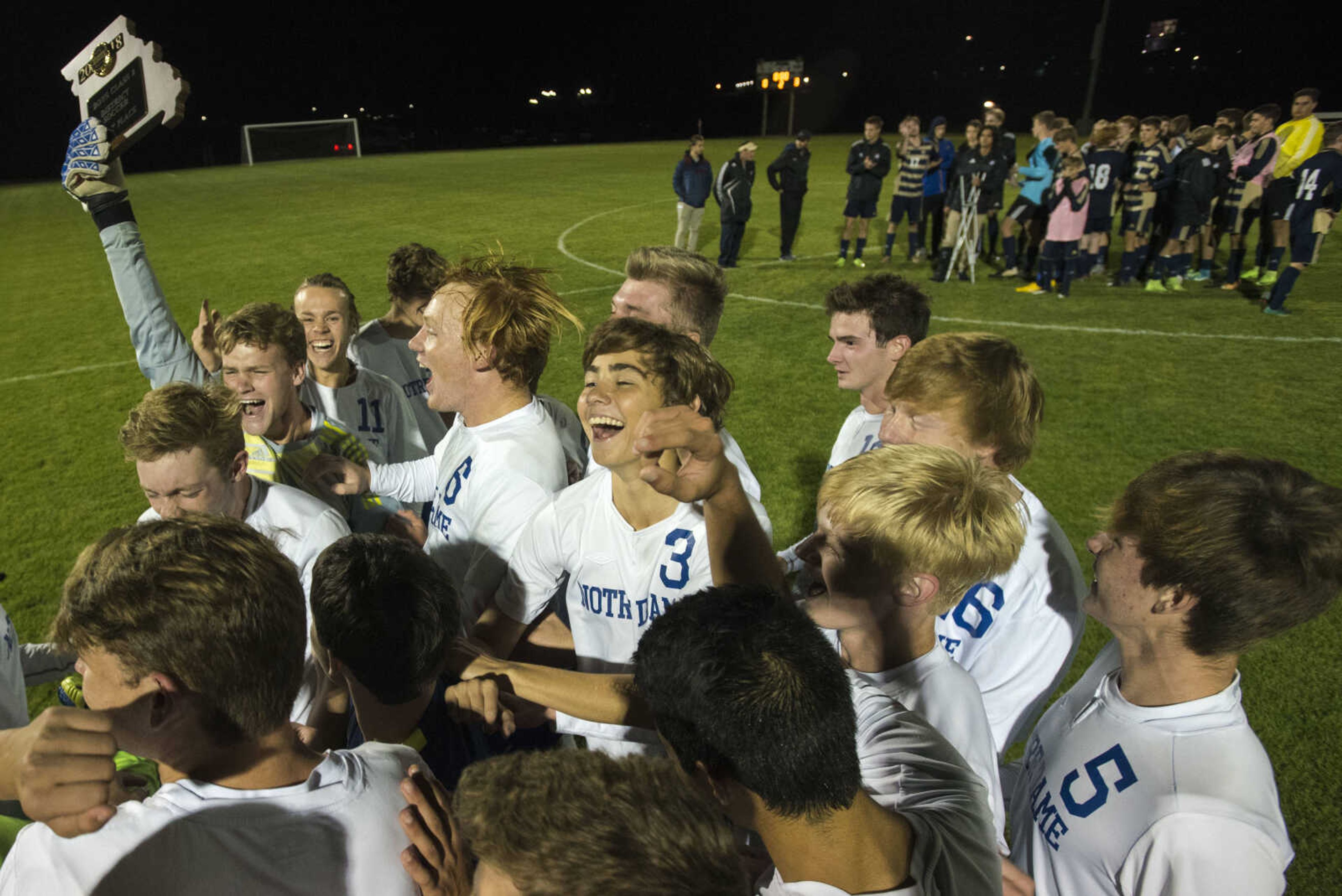 Notre Dame players celebrate with the first place district trophy after winning the Class 2 District 1 championship game against St. Pius X on Wednesday, Oct. 24, 2018 in Perryville, Missouri.