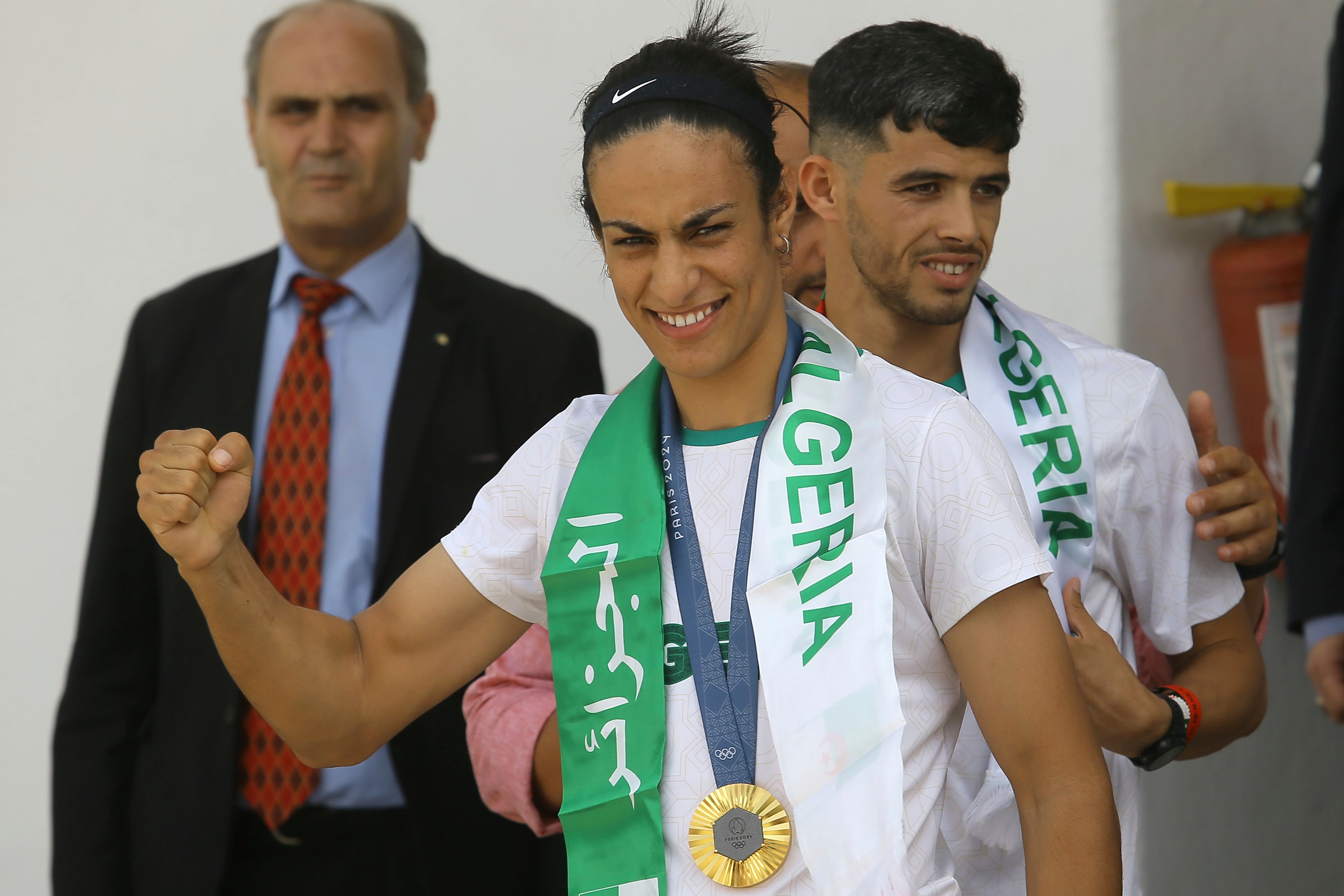 Gold medalist in the the women's 66 kg boxing Algeria's Imane Khelif, left, and bronze medalist in the men's 800m Djamel Sedjati arrive after the 2024 Summer Olympics, Monday, Aug. 12, 2024, at Algiers airport, Algeria. (AP Photo/Anis Belghoul)