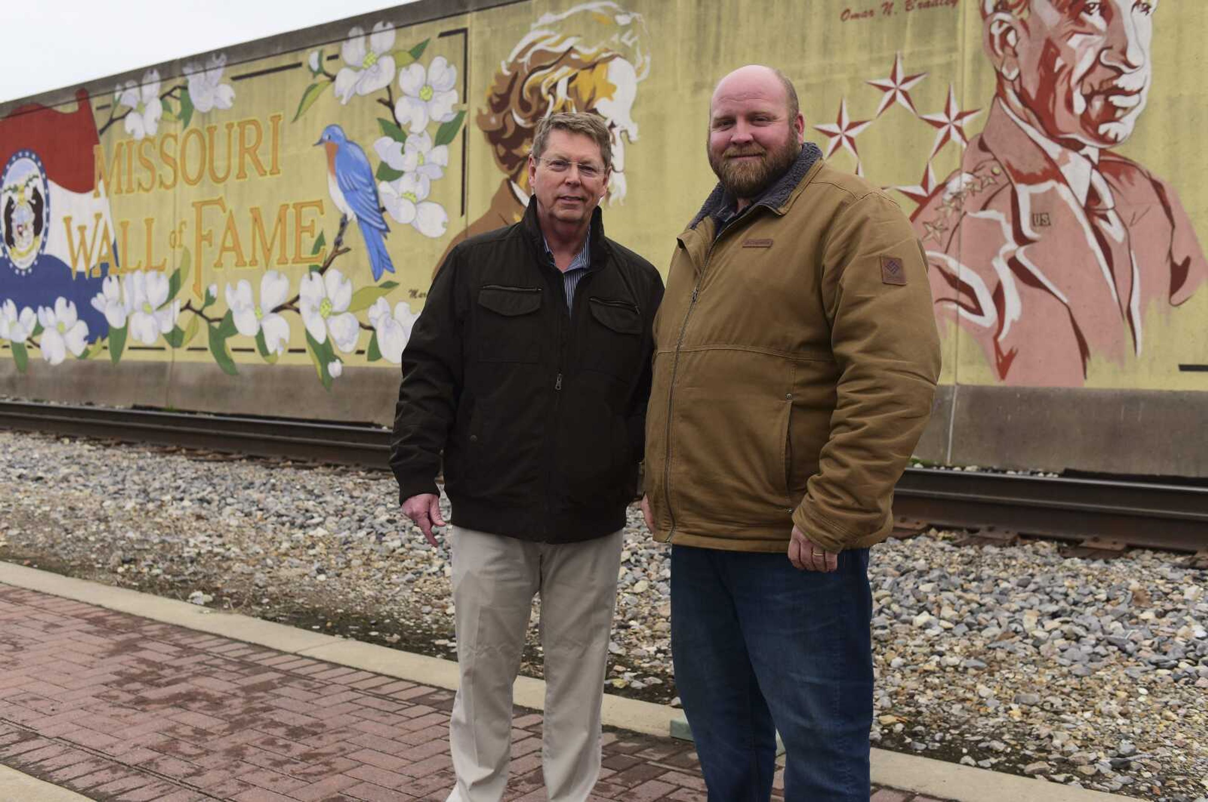 Brad McKee, left, and Tony Koeller pose for a photo Tuesday in front of the Missouri Wall of Fame in Cape Girardeau. Brad McKee's uncle, Gen. Seth J. McKee, who grew up in Cape Girardeau, is part of a campaign to add his uncle's image to the wall.