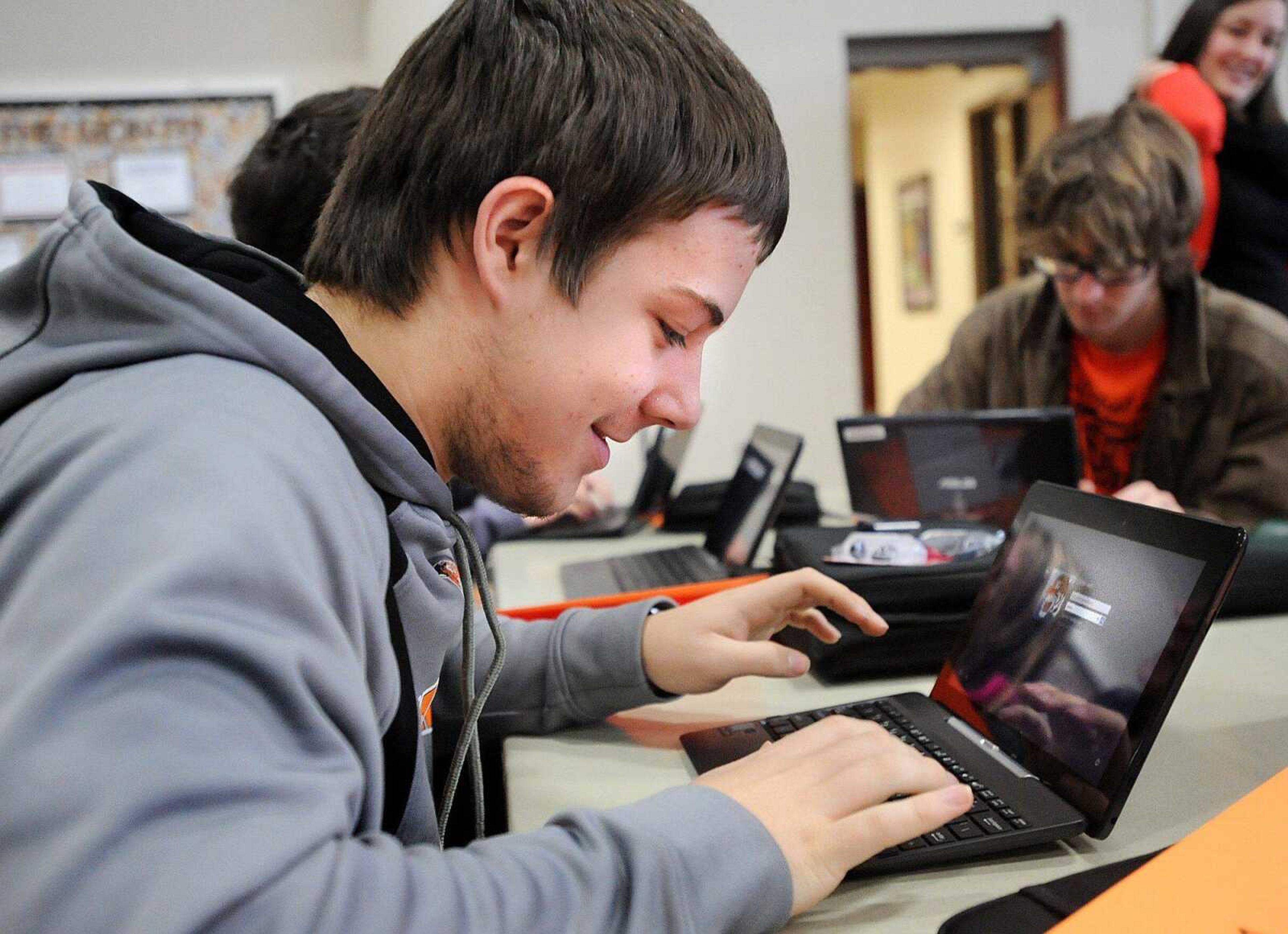 Kent Ragan checks out his new ASUS Transformer Book computer, Wednesday, Jan. 8, 2014. The computers, which can be used as a laptop or tablet, were distributed to all 1,200 high school students Wednesday morning. (Laura Simon)