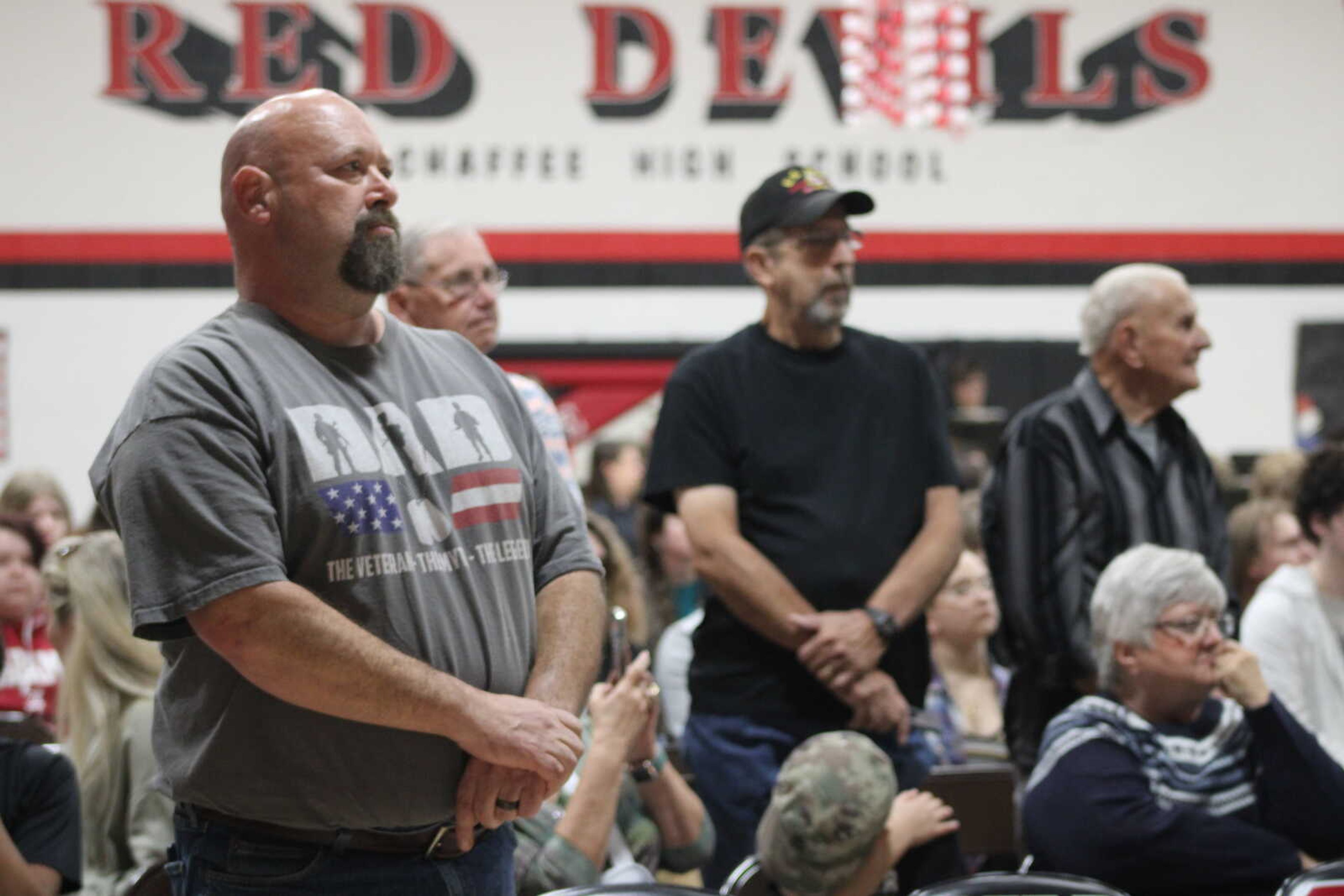 Veterans in attendee stand when their branch is called during the Armed Forces on Parade played by the Chaffee High school band.&nbsp;