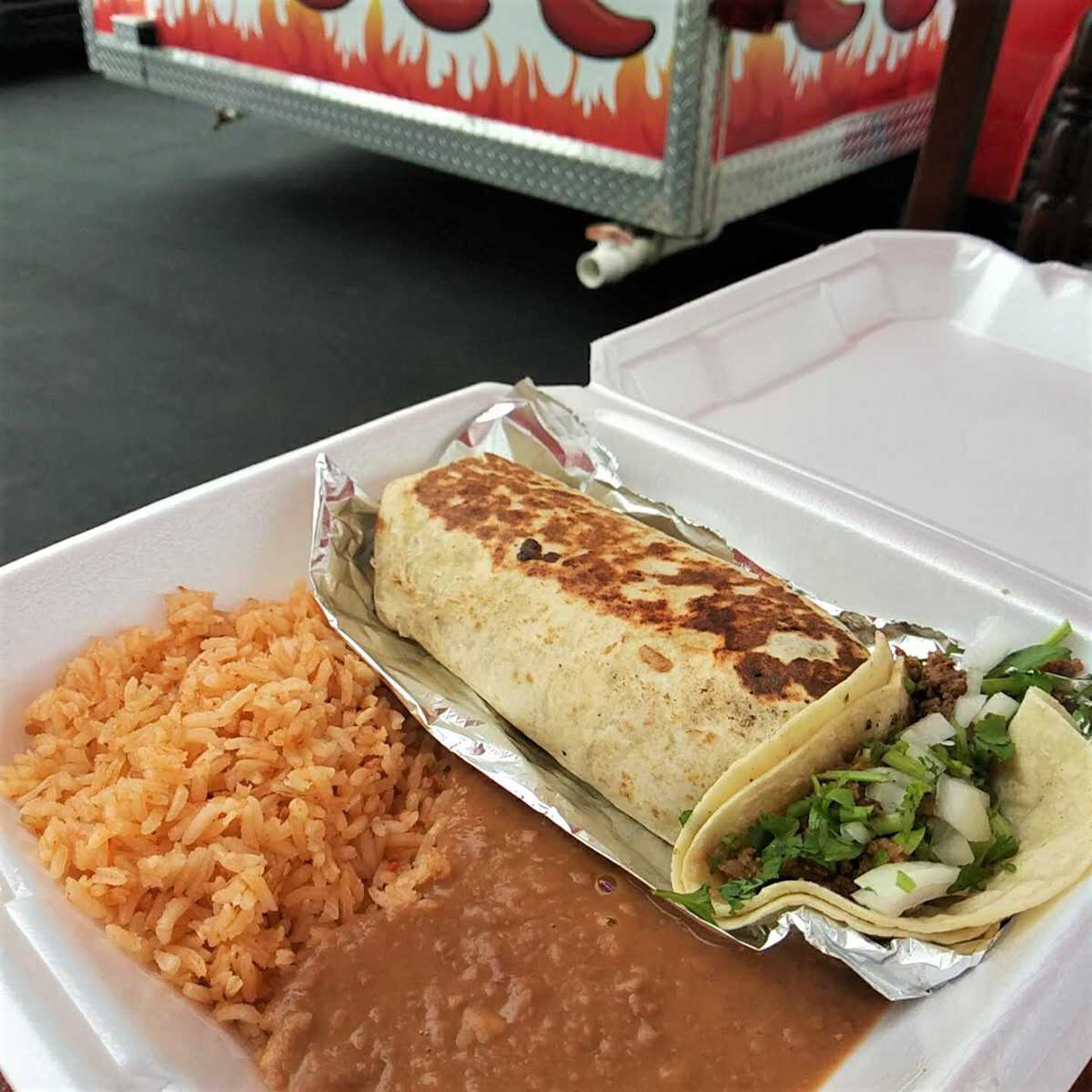 A burrito and street taco from LT's Street Tacos, cooked and in our hands  Almost Fast.