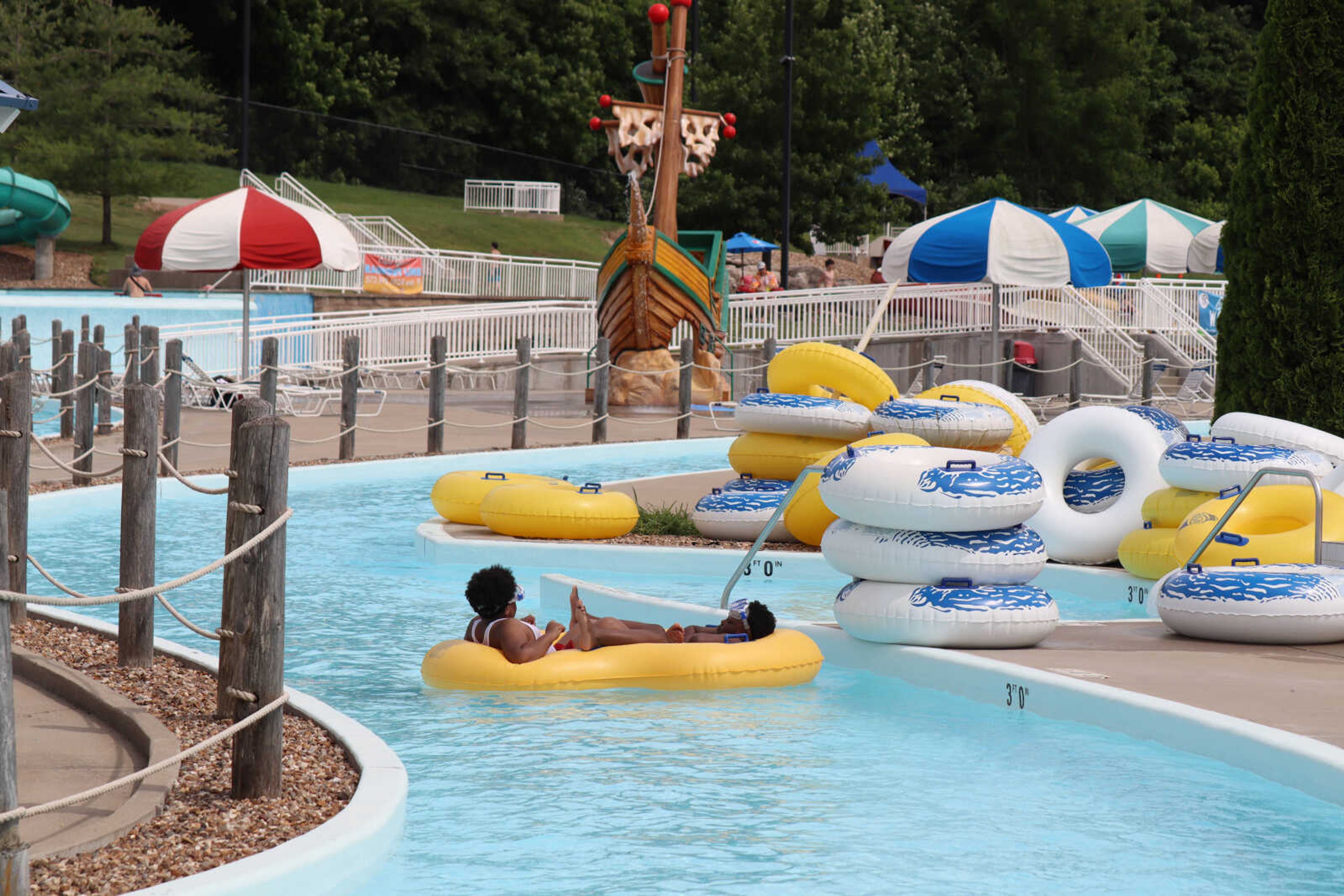 Two kids make their way down the lazy river in a double tube on Thursday.