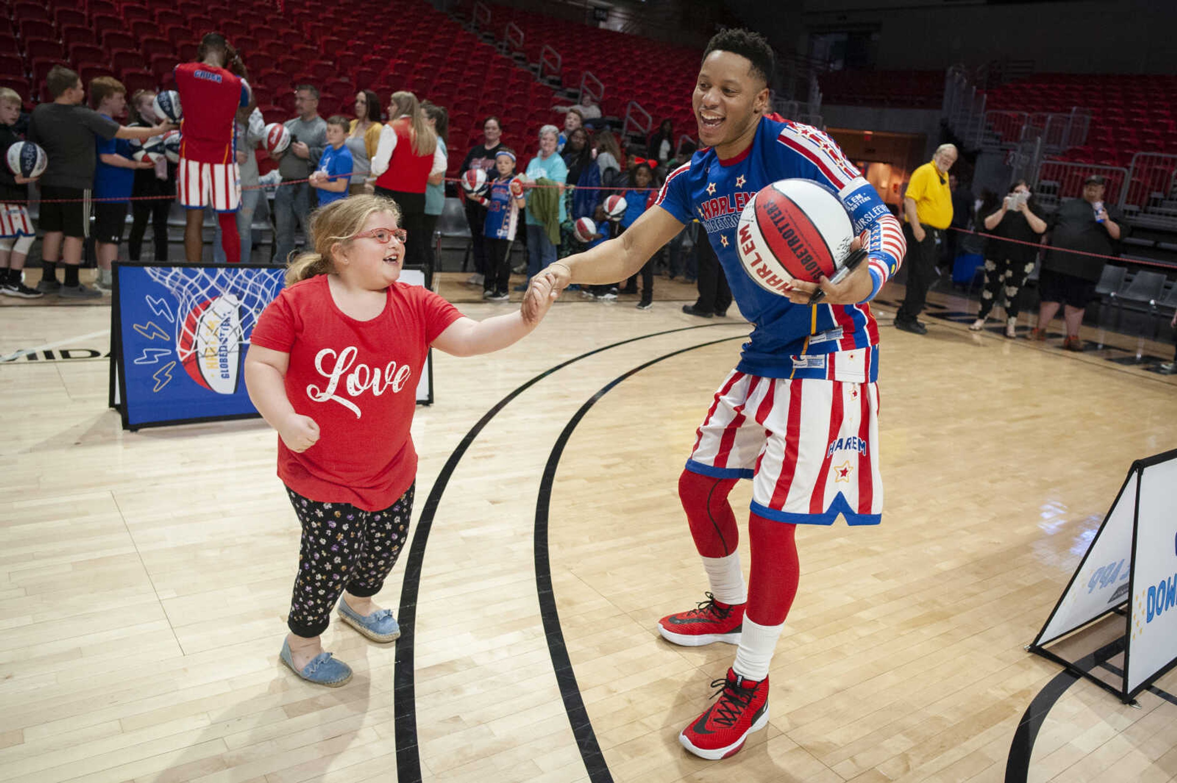 Daelyn McIntyre, 7, of Bonne Terre, Missouri, dances with Harlem Globetrotters guard "Jet Rivers" during the Harlem Globetrotters' visit to the Show Me Center on Monday, Feb. 3, 2020, in Cape Girardeau. The Globetrotters defeated the Washington Generals 58-54.