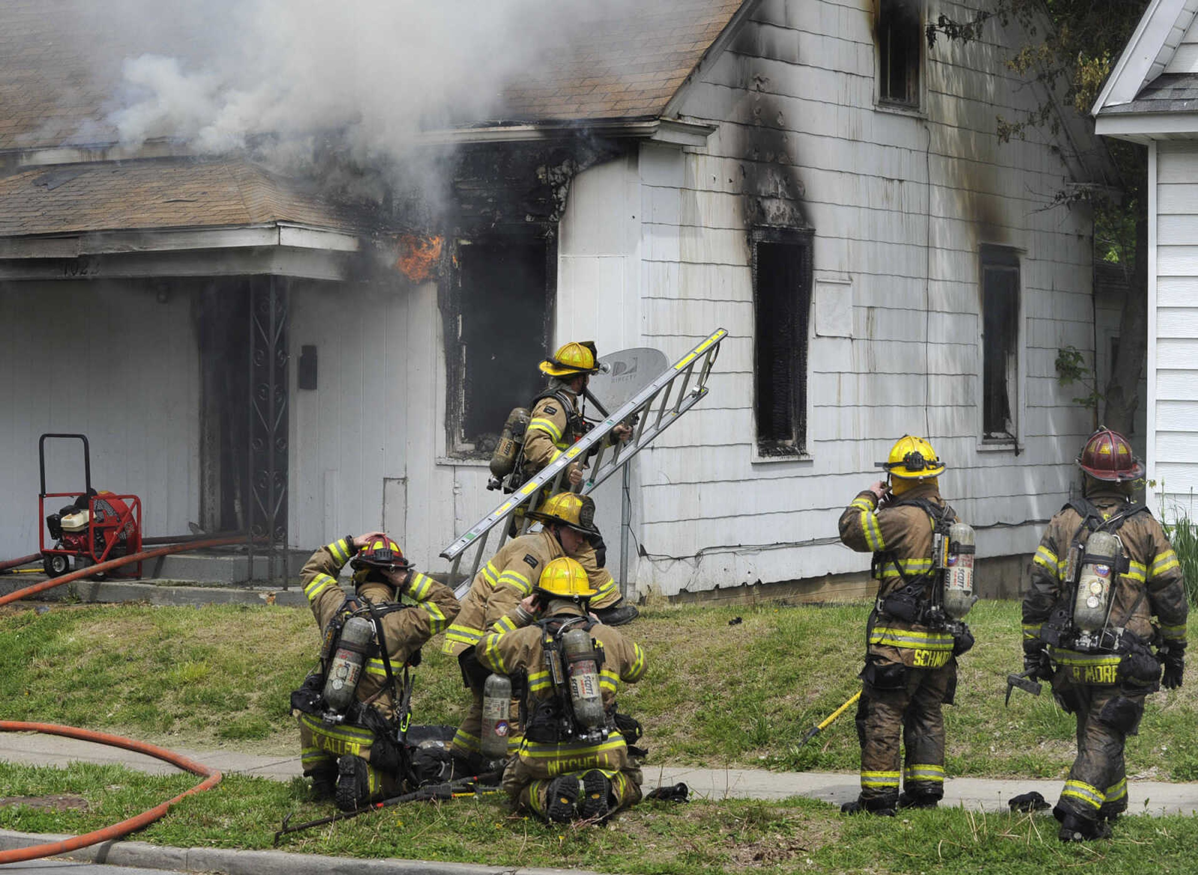 Cape Girardeau firefighters work a house fire Tuesday morning, April 28, 2015 at 1022 Jefferson Avenue in Cape Girardeau.