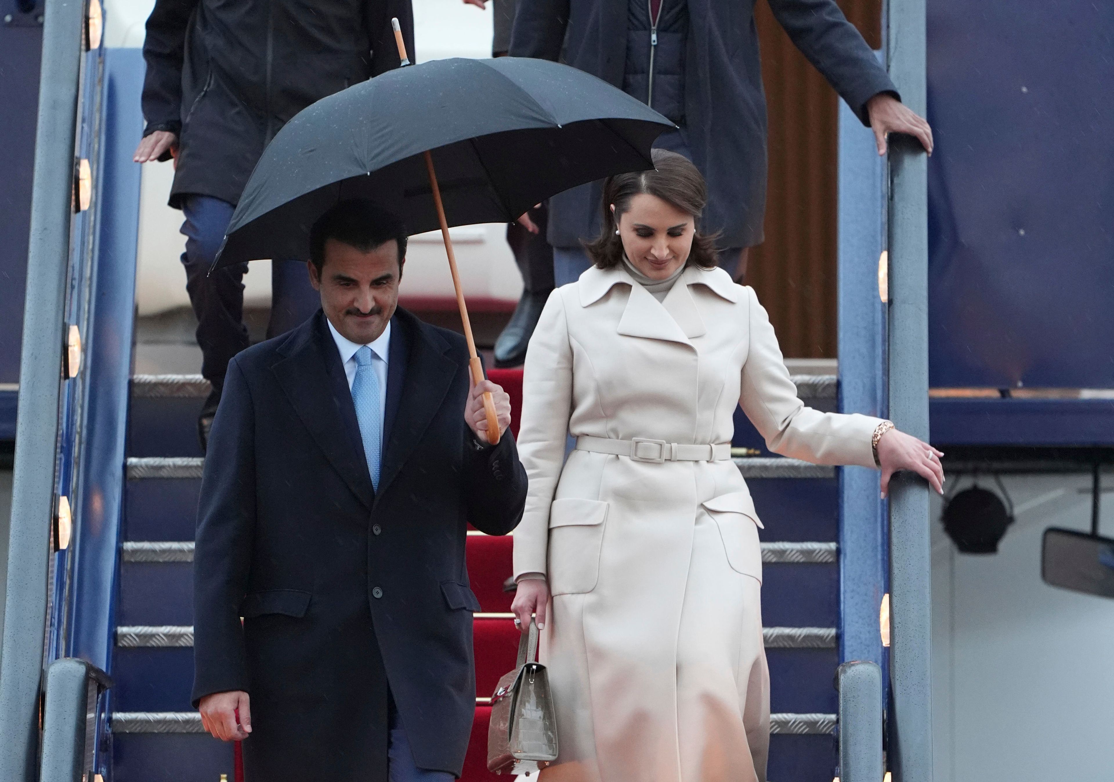 Emir of Qatar Sheikh Tamim bin Hamad bin Khalifa Al Thani, front left, and Sheikha Hind bint Hamad bin Khalifa al-Thani, front right, arrive at Stansted Airport in Essex, England, Monday Dec. 2, 2024, for a state visit hosted by King Charles III. ( Joe Giddens/PA via AP)