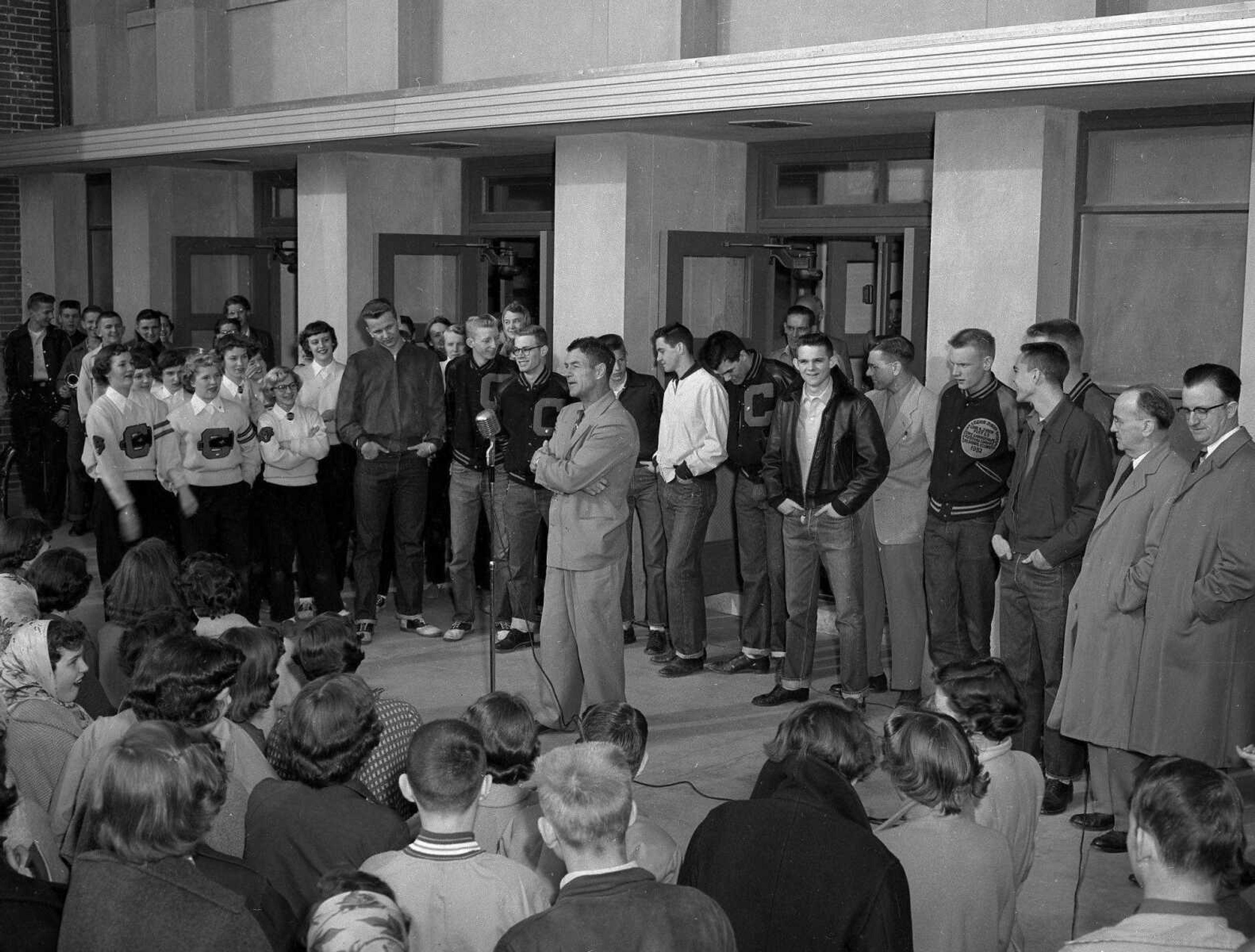 Coach Louis W. Muegge speaks to Central High School students, with his 1954 state champion Tigers basketball team behind him, following the 79-55 win over the Christian Brothers Cadets of St. Louis. It was the first state basketball title for Central. The game was played at Houck Field House on March 6, 1954. Read the story here: <a href="http://www.semissourian.com/blogs/flynch/entry/33455">www.semissourian.com/blogs/flynch/entry/33455</a>