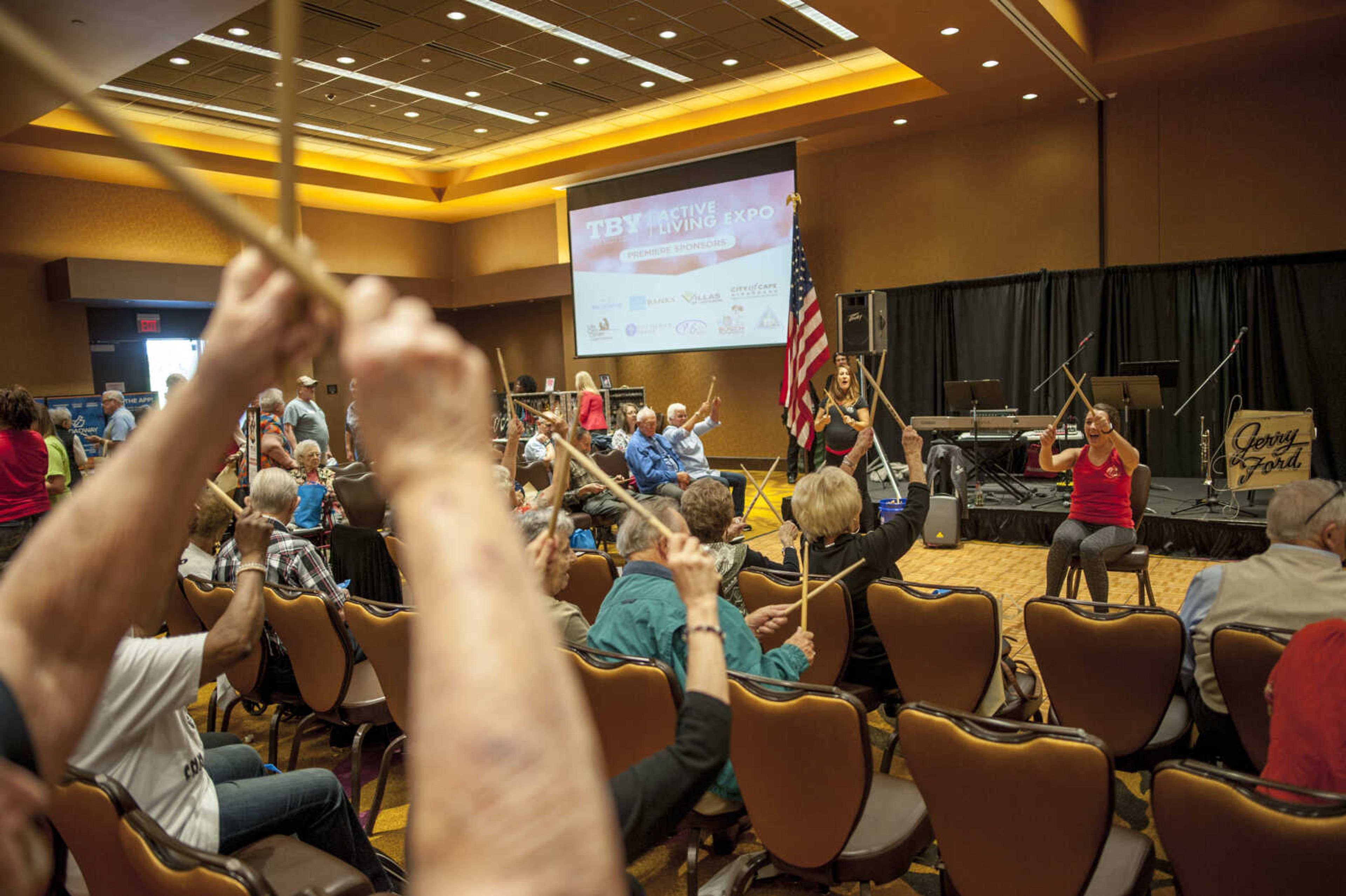 Attendees drum along to a cardio routine during the TBY Active Living Expo in Cape Girardeau in 2019.