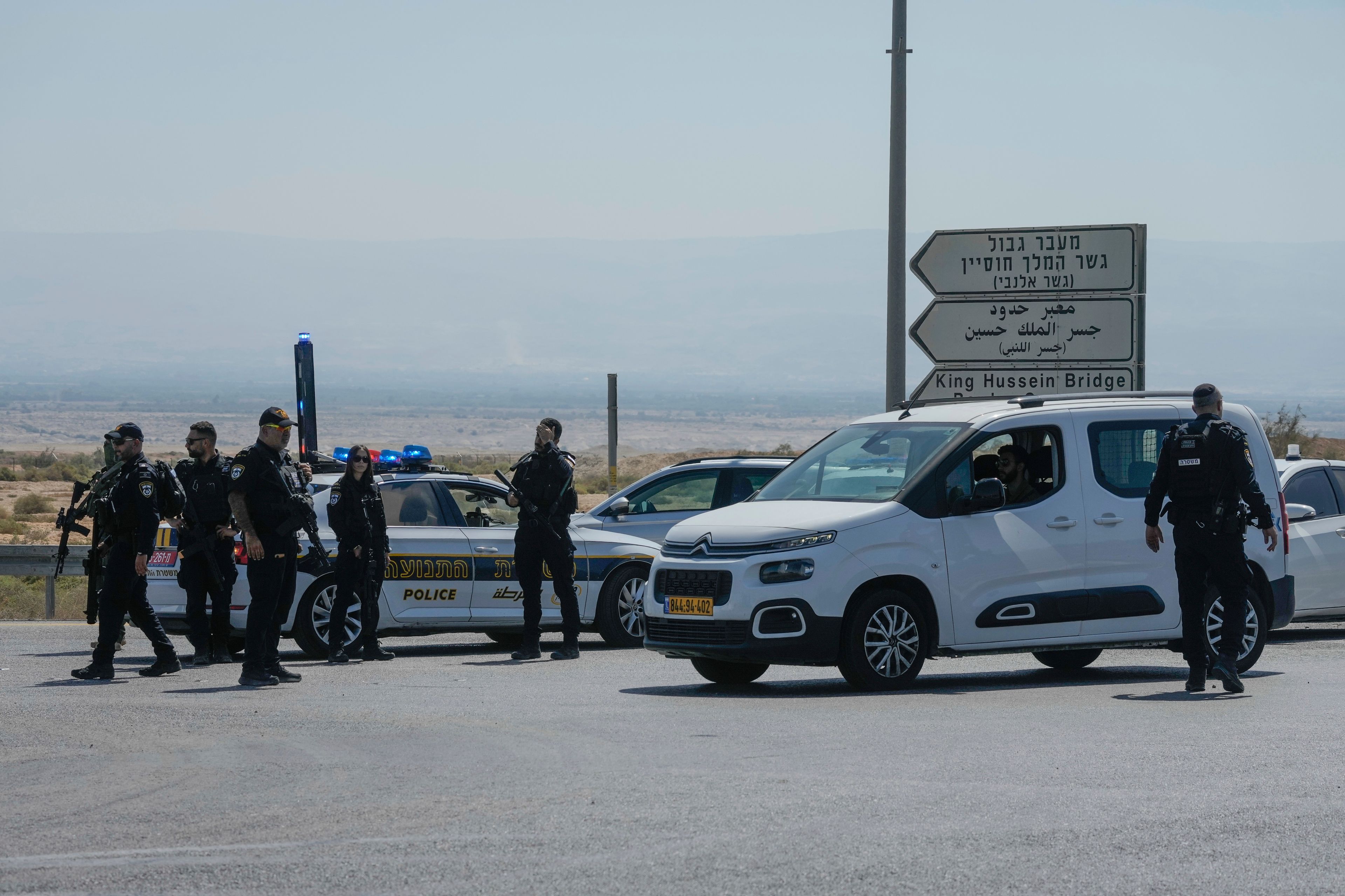 Israeli police stand guard near the site of a deadly shooting attack where Israeli officials say three people were shot and killed at the Allenby Bridge Crossing between the West Bank and Jordan, Sunday, Sept. 8, 2024. (AP Photo/Mahmoud Illean)