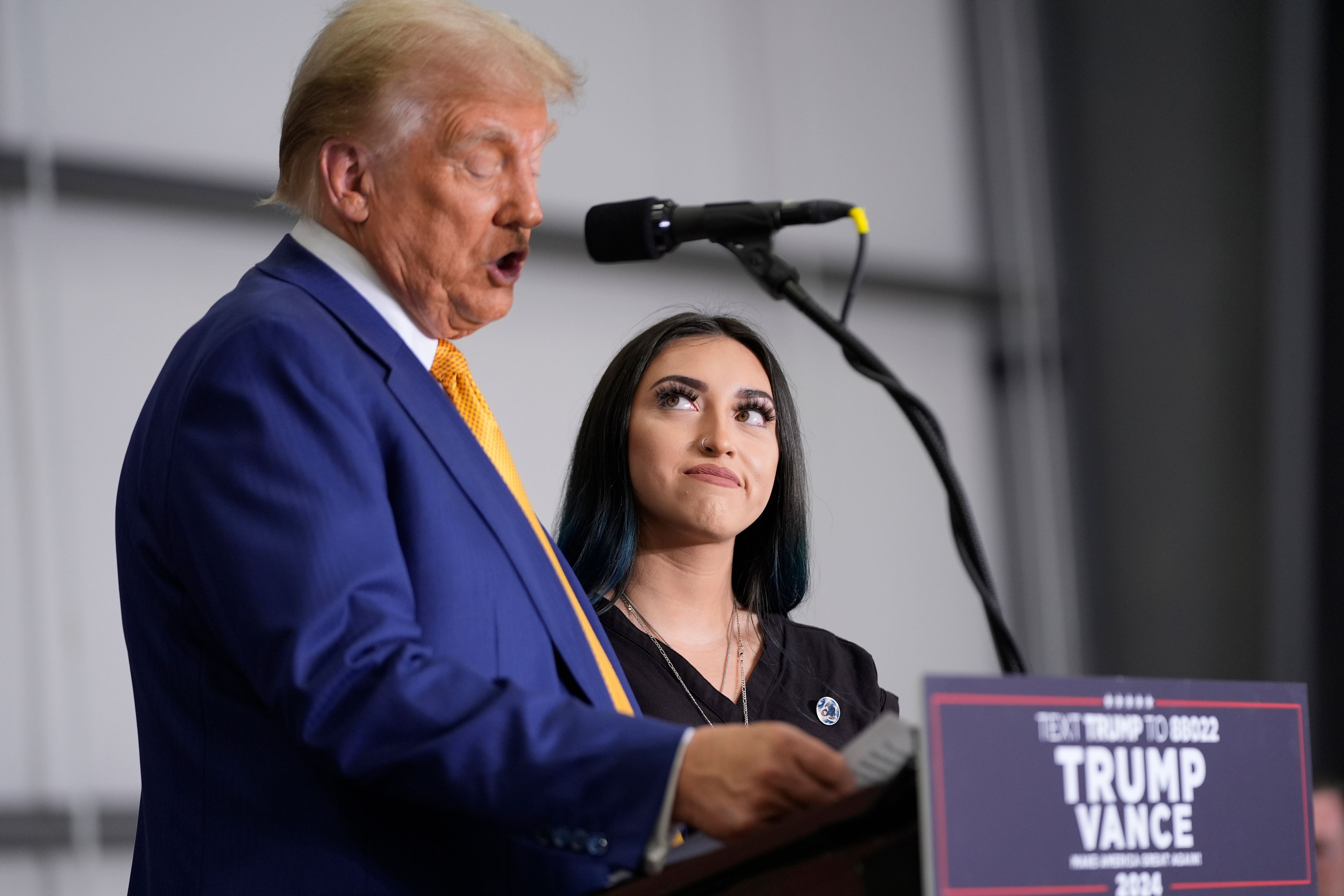 Republican presidential nominee former President Donald Trump speaks as Alexis Nungaray, mother of the late Jocelyn Nungaray, listens during a news conference at Austin-Bergstrom International Airport, Friday, Oct. 25, 2024, in Austin, Texas. (AP Photo/Alex Brandon)