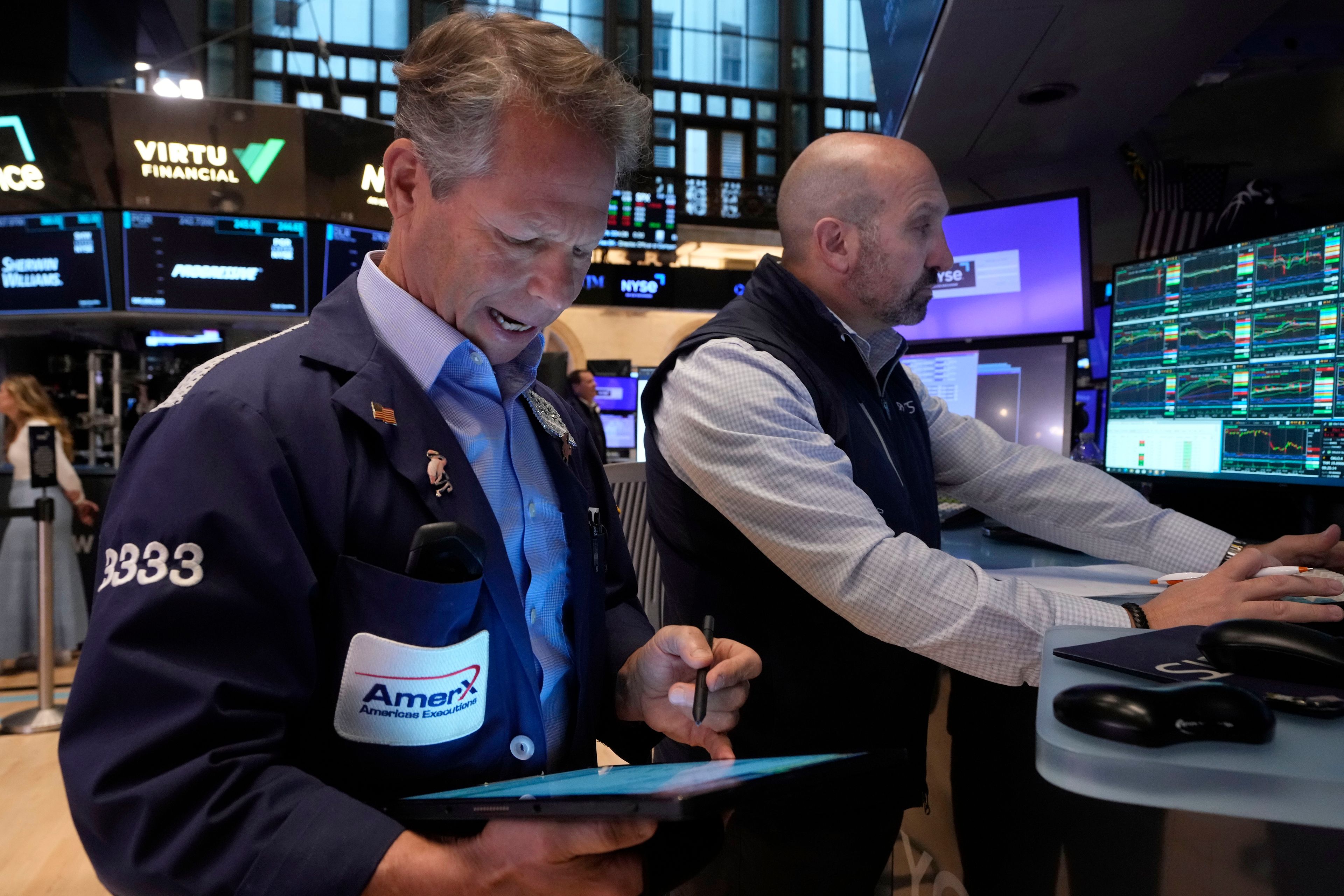 Trader Robert Chamak, left, and specialist James Denaro work on the floor of the New York Stock Exchange, Monday, Nov. 4, 2024. (AP Photo/Richard Drew)