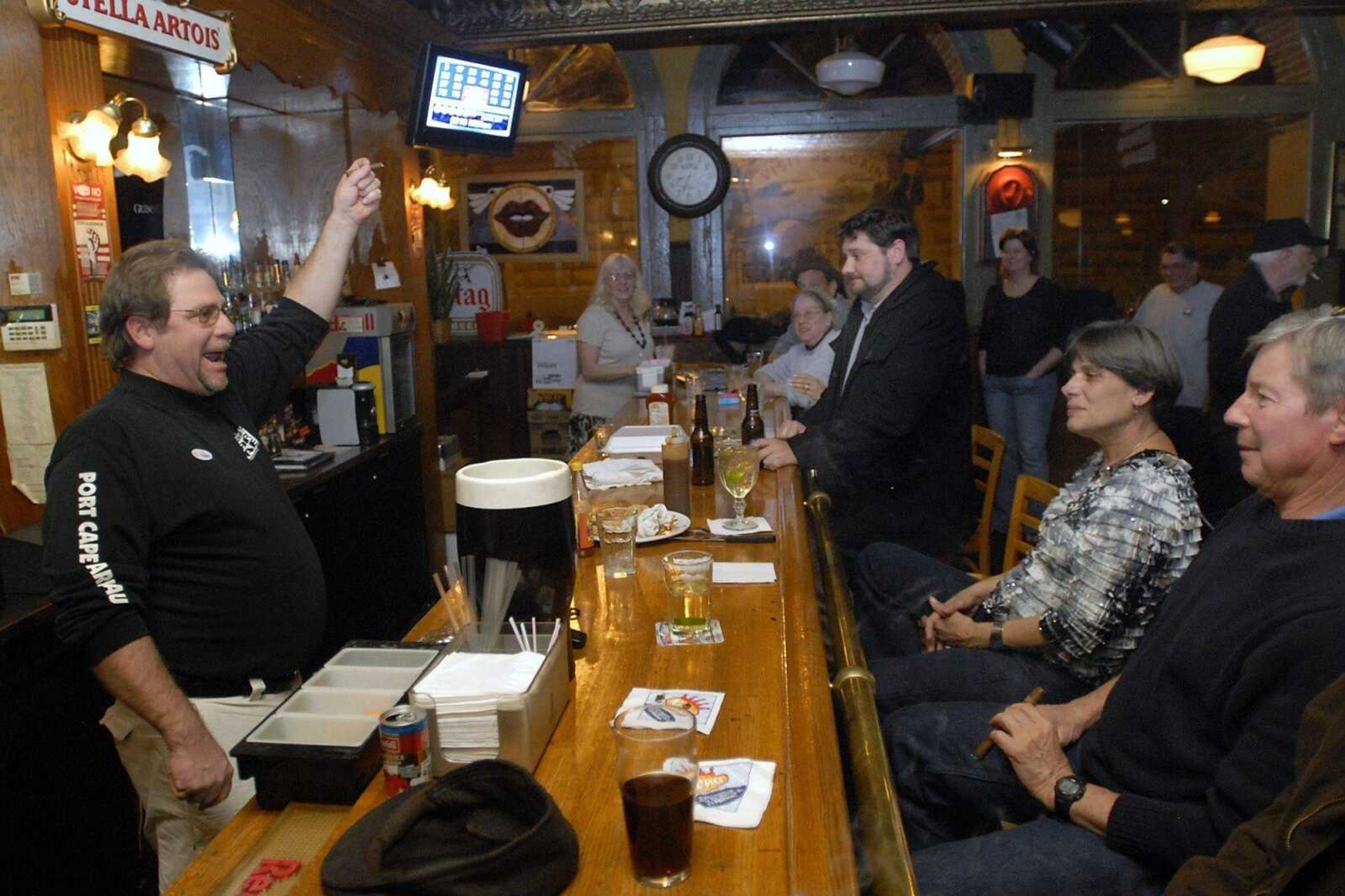 Doc Cain, left, owner of Port Cape Girardeau and member of "Stand Up Cape, What's Next?", congratulates the crowd in his bar after unofficial results came in showing the smoking ban question was defeated 3,997 to 3,672, or 52.12 percent to 47.88 percent, on Tuesday, April 5, 2011. (Kristin Eberts)