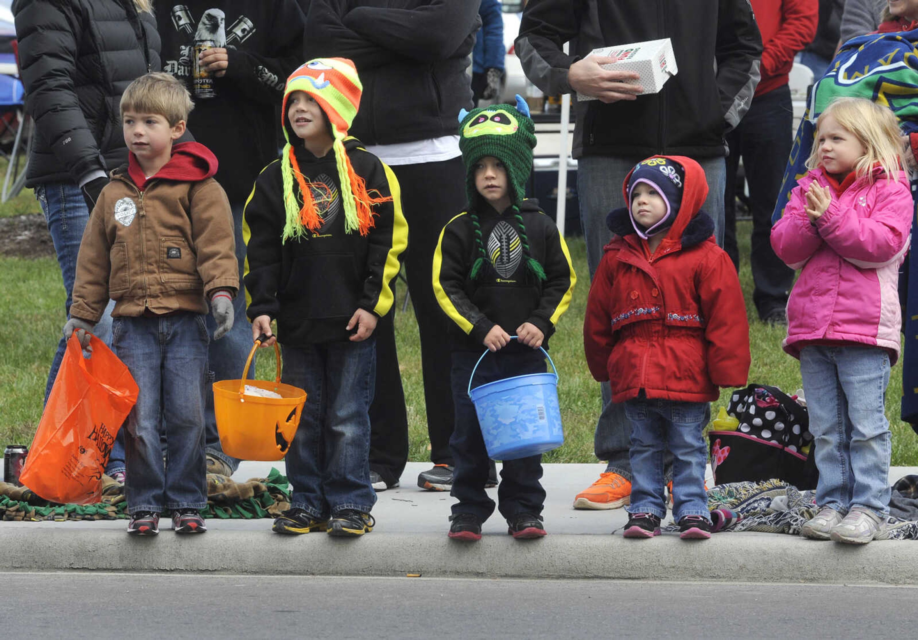 Children stand along the route of the SEMO Homecoming parade Saturday, Oct. 26, 2013 on Broadway in Cape Girardeau.