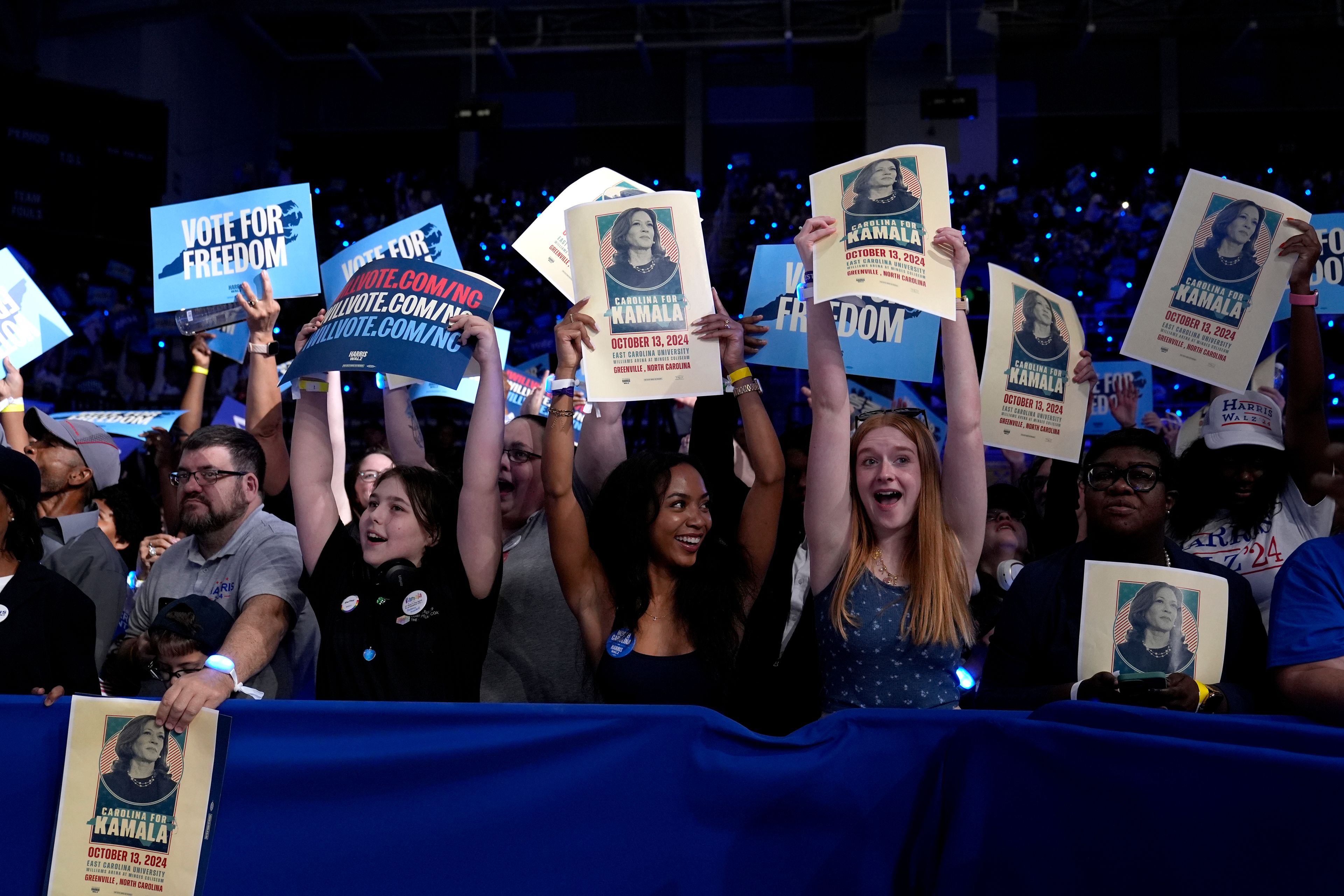 Attendees do the wave as they wait for Democratic presidential nominee Vice President Kamala Harris to speaks at a campaign rally at East Carolina University in Greenville, N.C., Sunday, Oct. 13, 2024. (AP Photo/Susan Walsh)