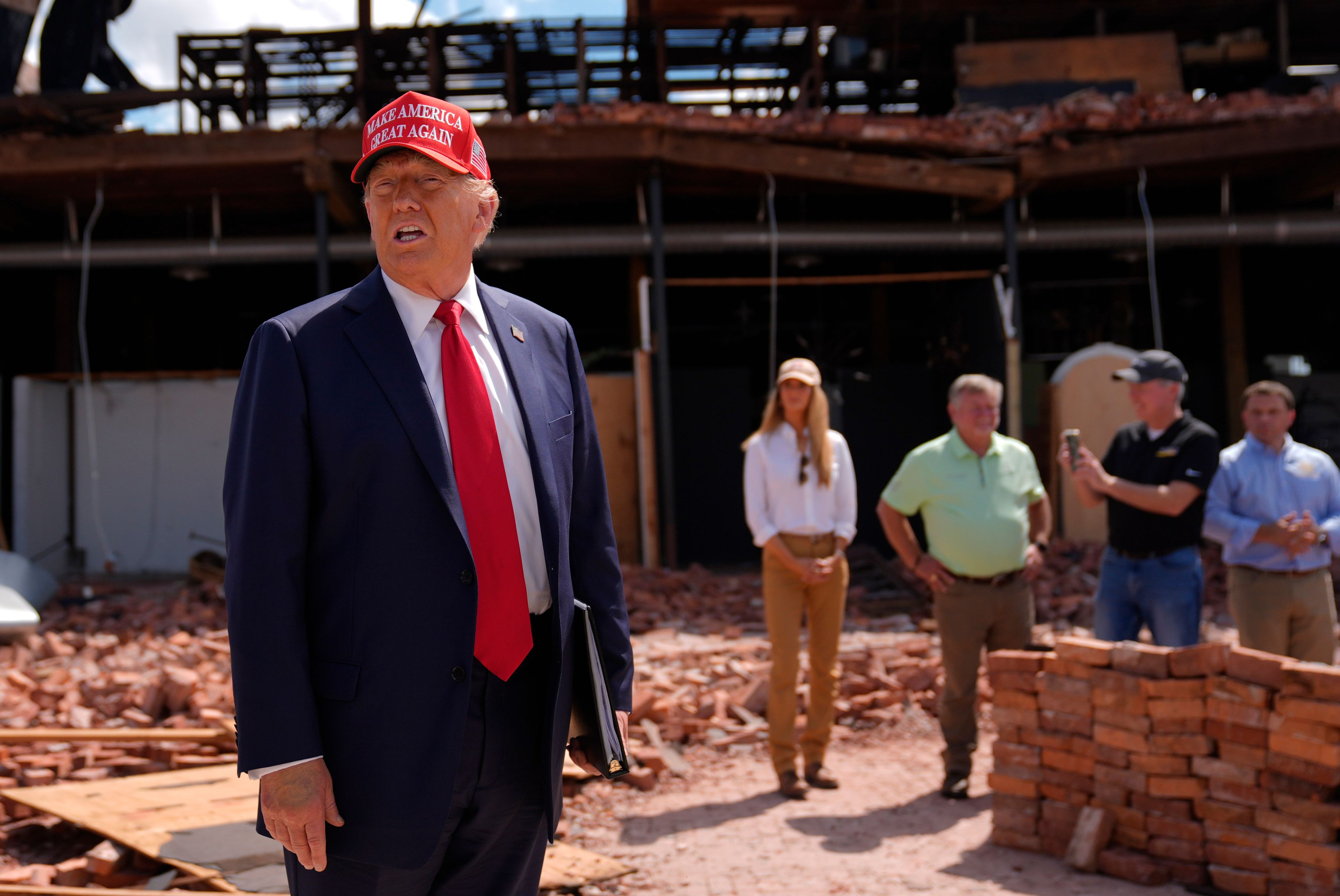 Republican presidential nominee former President Donald Trump speaks as he visits downtown Valdosta, Ga., a town that was impacted by Hurricane Helene, Monday, Sept. 30, 2024. (AP Photo/Evan Vucci)