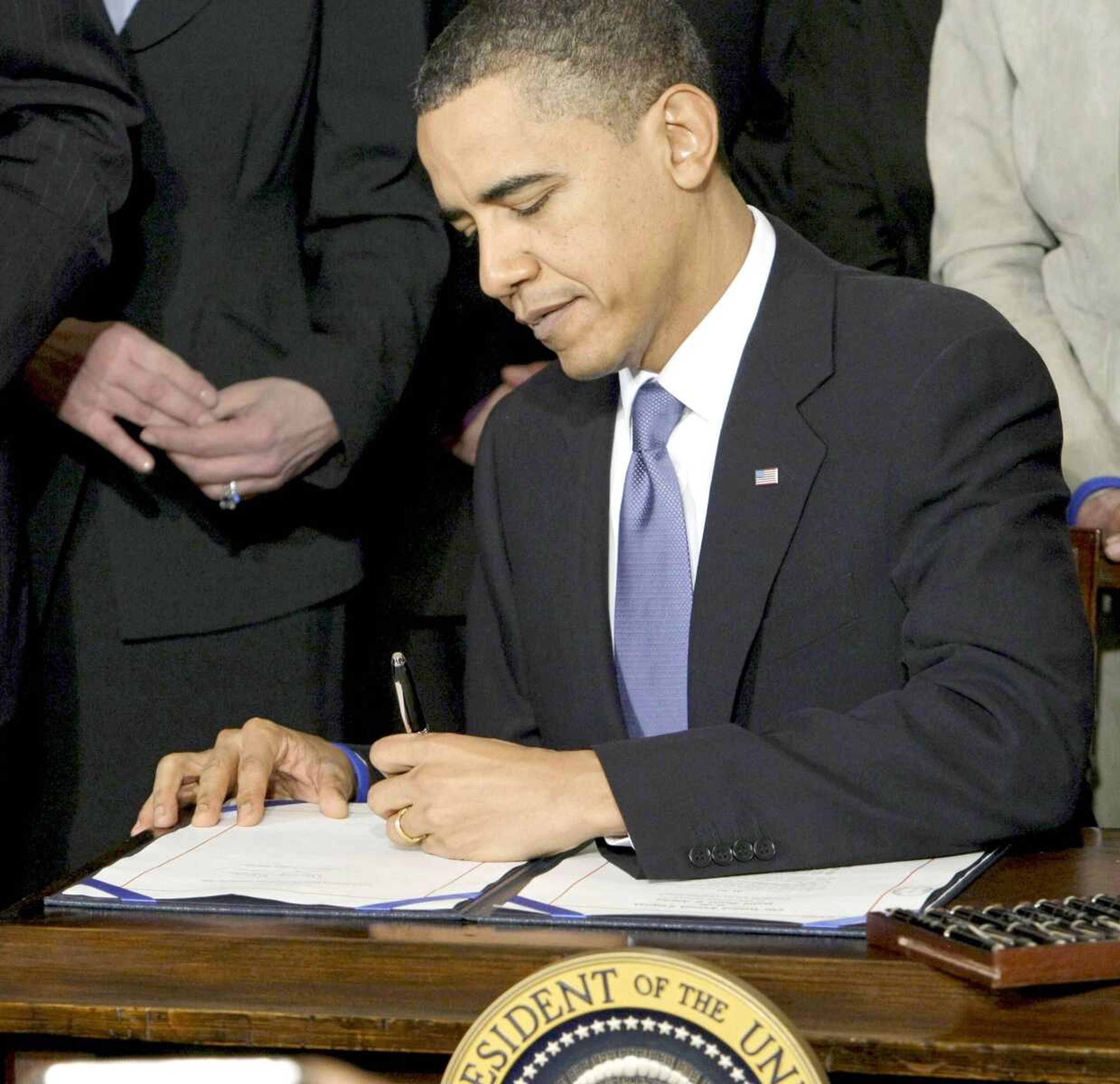 President Barack Obama signs the health care bill March 23, 2010, in Washington. The Obama administration released a blueprint Monday for states to match up uninsured Americans with coverage that&#8217;s right for them under the health care law. <br>Scott Applewhite<br>Associated Press