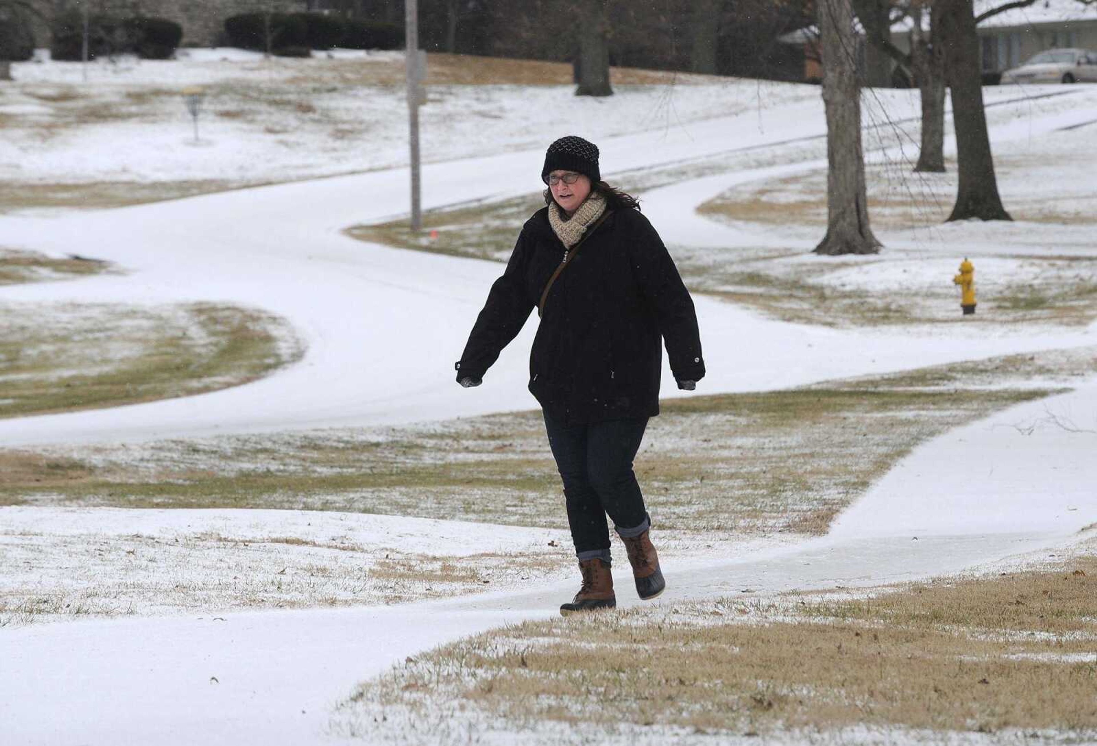 Kirstin Sheehan takes a careful winter walk Friday at Capaha Park in Cape Girardeau.