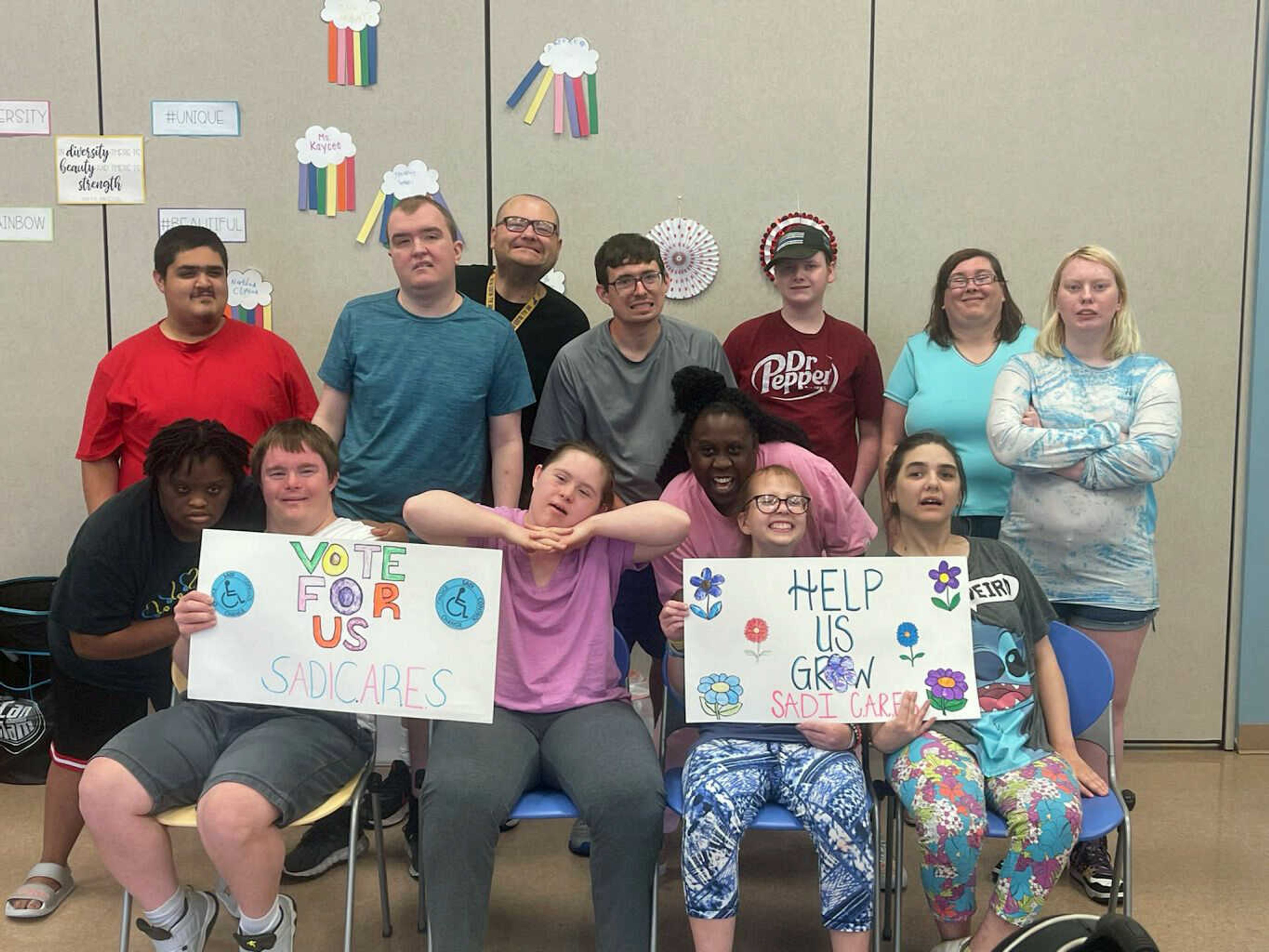 Participants of SEMO Alliance for Disability Independence's Community, Activities, Recreation, Education and Socialization day program with True Inspiration Awards campaign signs.