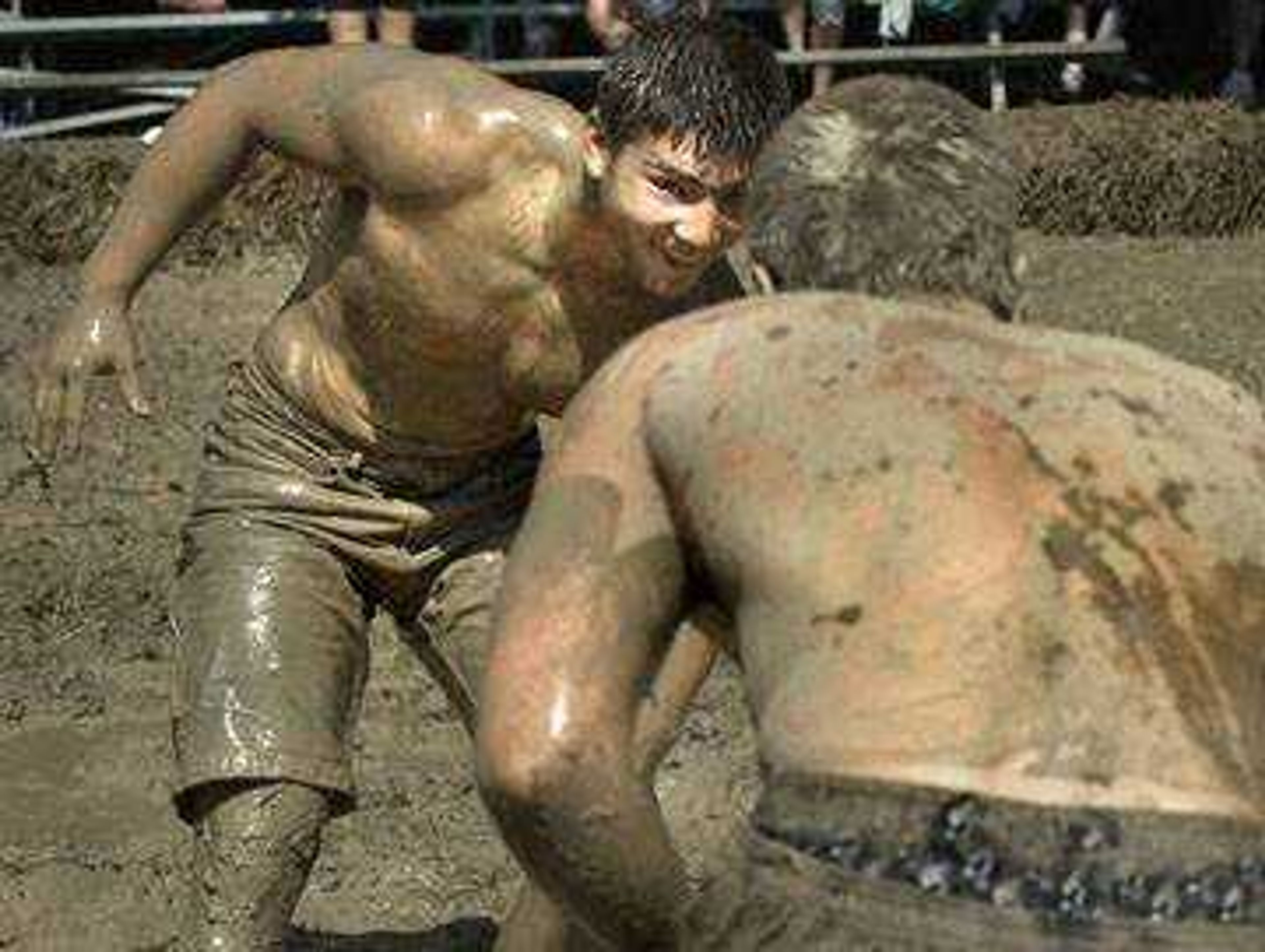 Matt Kahle of Jackson prepared to take down one of his mud volleyball teammates after their match.