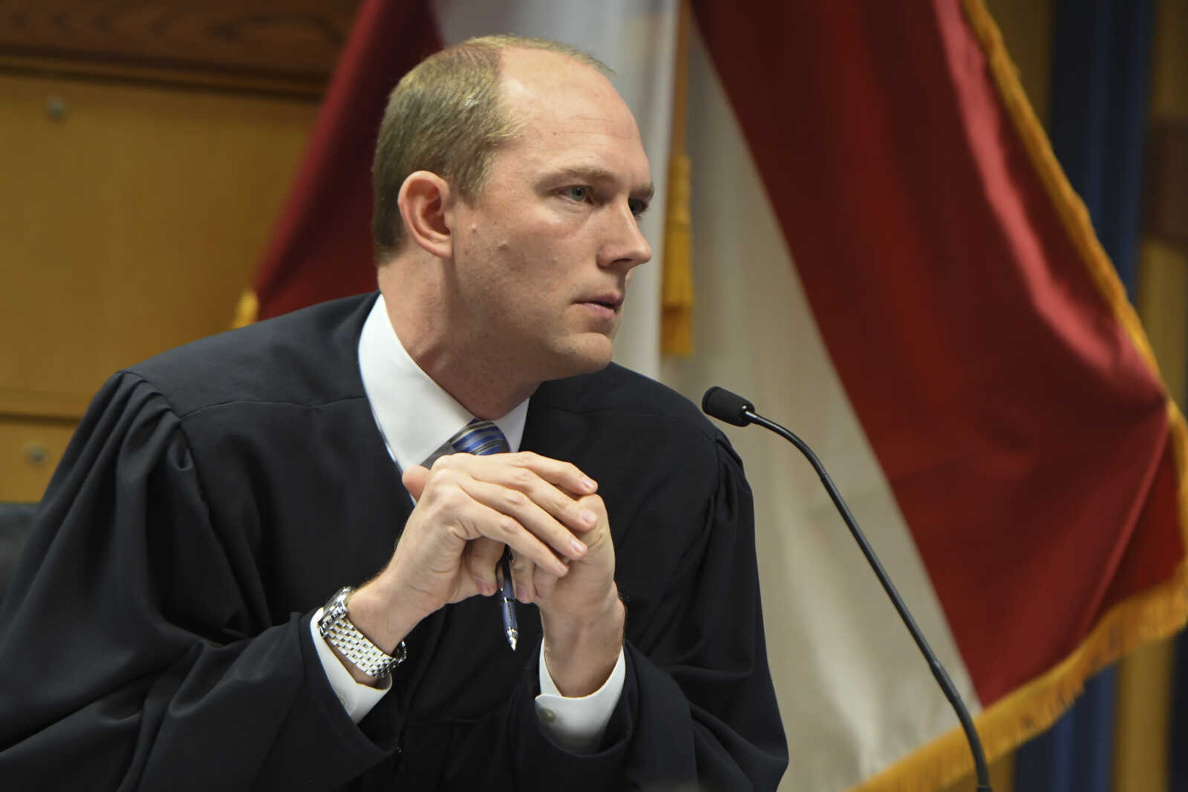 Judge Scott McAfee addresses the lawyers during a hearing on charges against former President Donald Trump in the Georgia election interference case on Thursday, March 28, 2024 in Atlanta.  Lawyers for Trump argued in a court filing that the charges against him in the Georgia election interference case seek to criminalize political speech and advocacy conduct that is protected by the First Amendment. (Dennis Byron/Hip Hop Enquirer via AP)