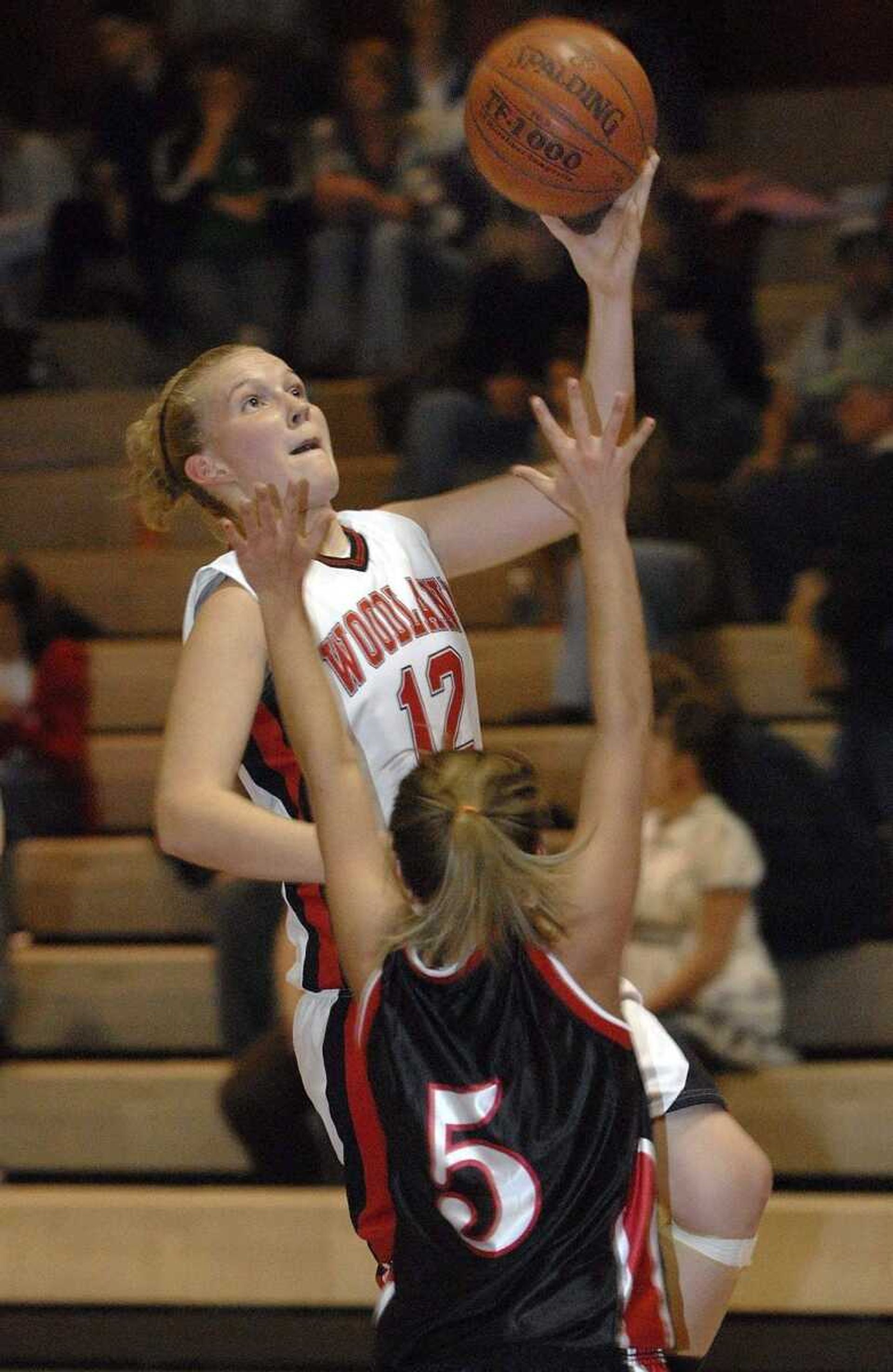 FRED LYNCH ~ flynch@semissourian.comWoodland's Taylor Steckman goes up for a shot over Meadow Heights defender Ashley Dublin in the second quarter Thursday at Woodland. A photo gallery from the game is available at semissourian.com.