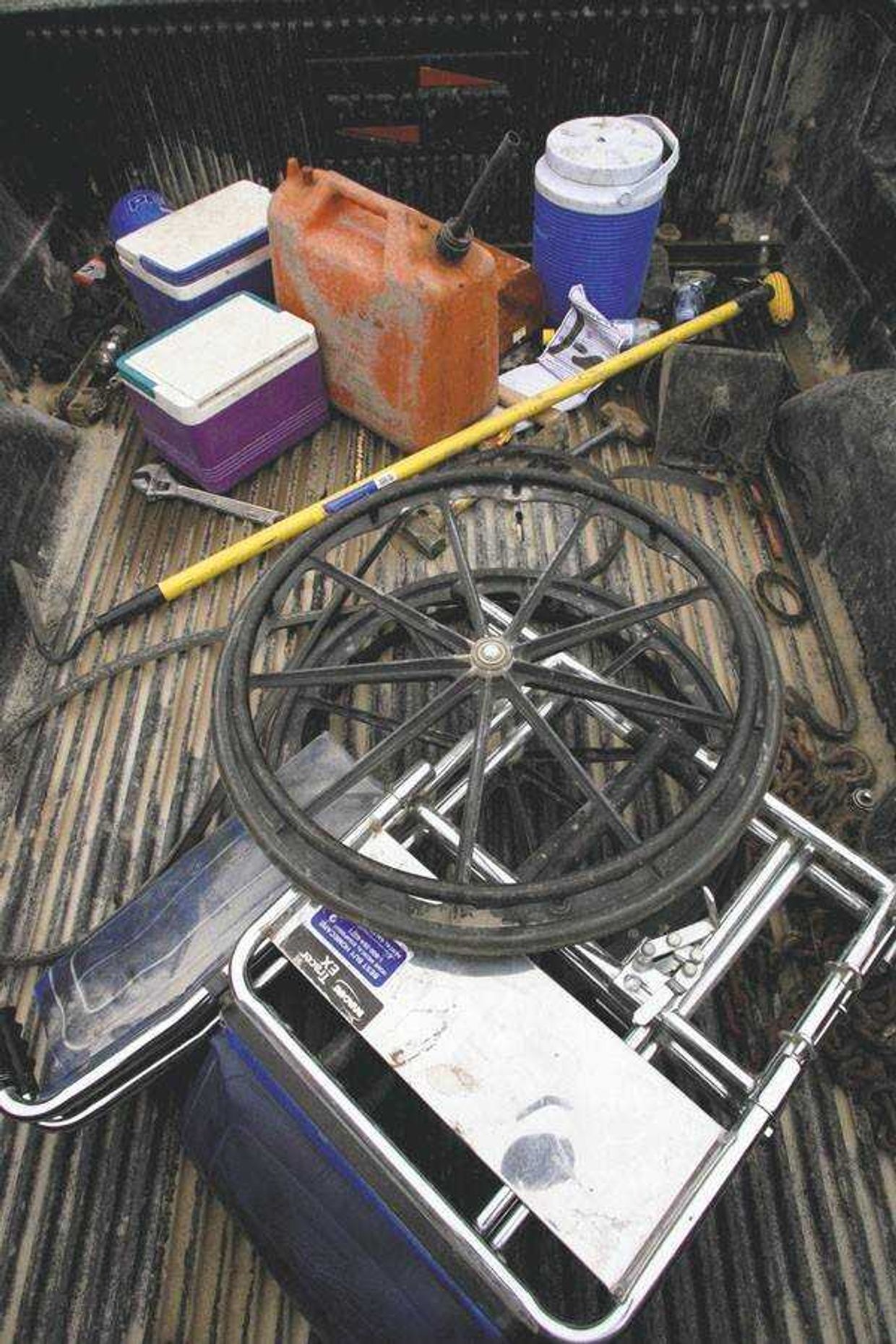 The wheelchair of Andy Leake sat in the bed of his pickup truck with other tools of the trade at harvest time.