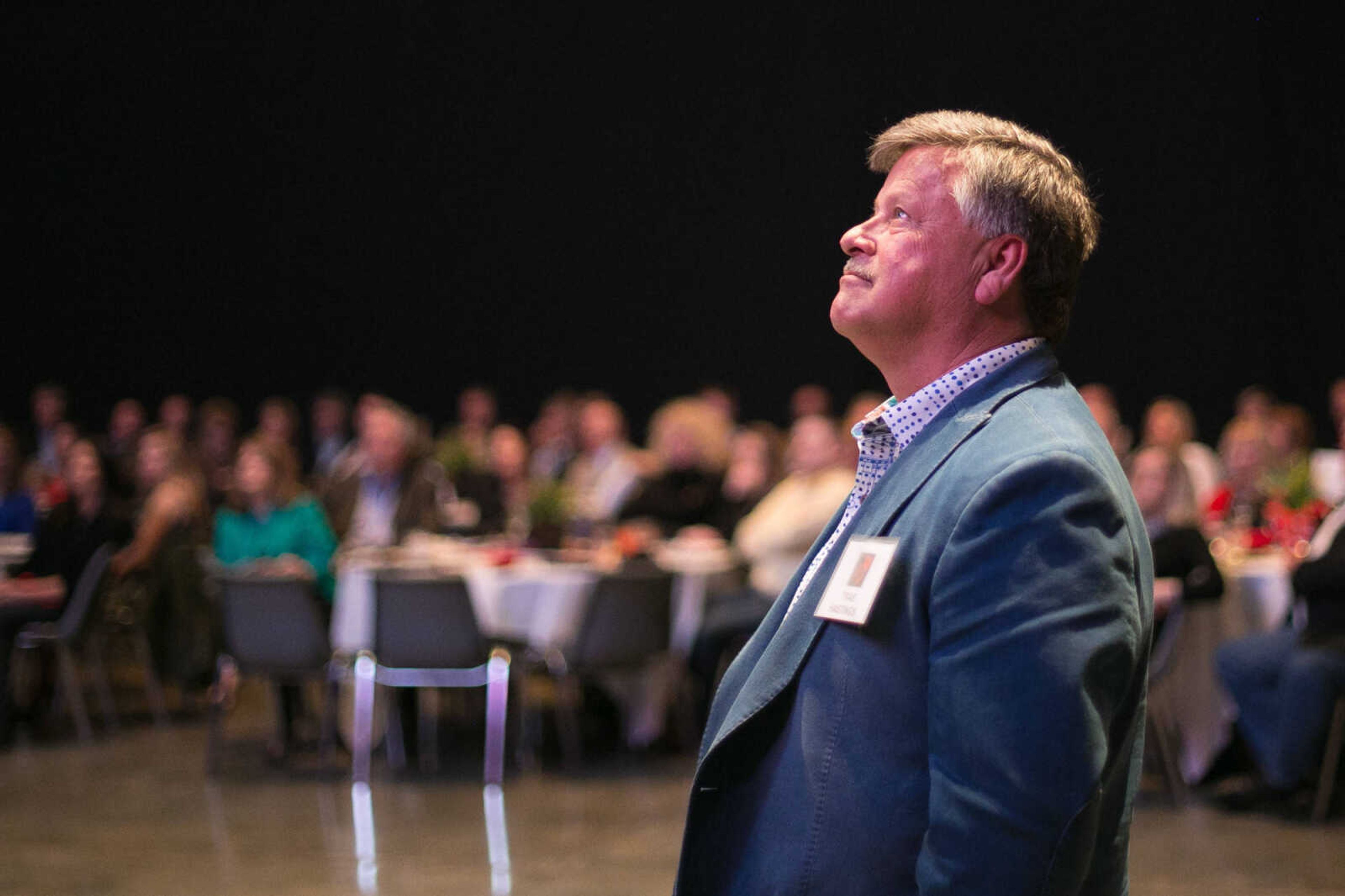 Trae Hastings (Baseball 1975-1978) watches a video introduction during his induction into the Southeast Missouri State University Athletic Hall of Fame Friday, Feb. 19, 2016 at the Show Me Center.