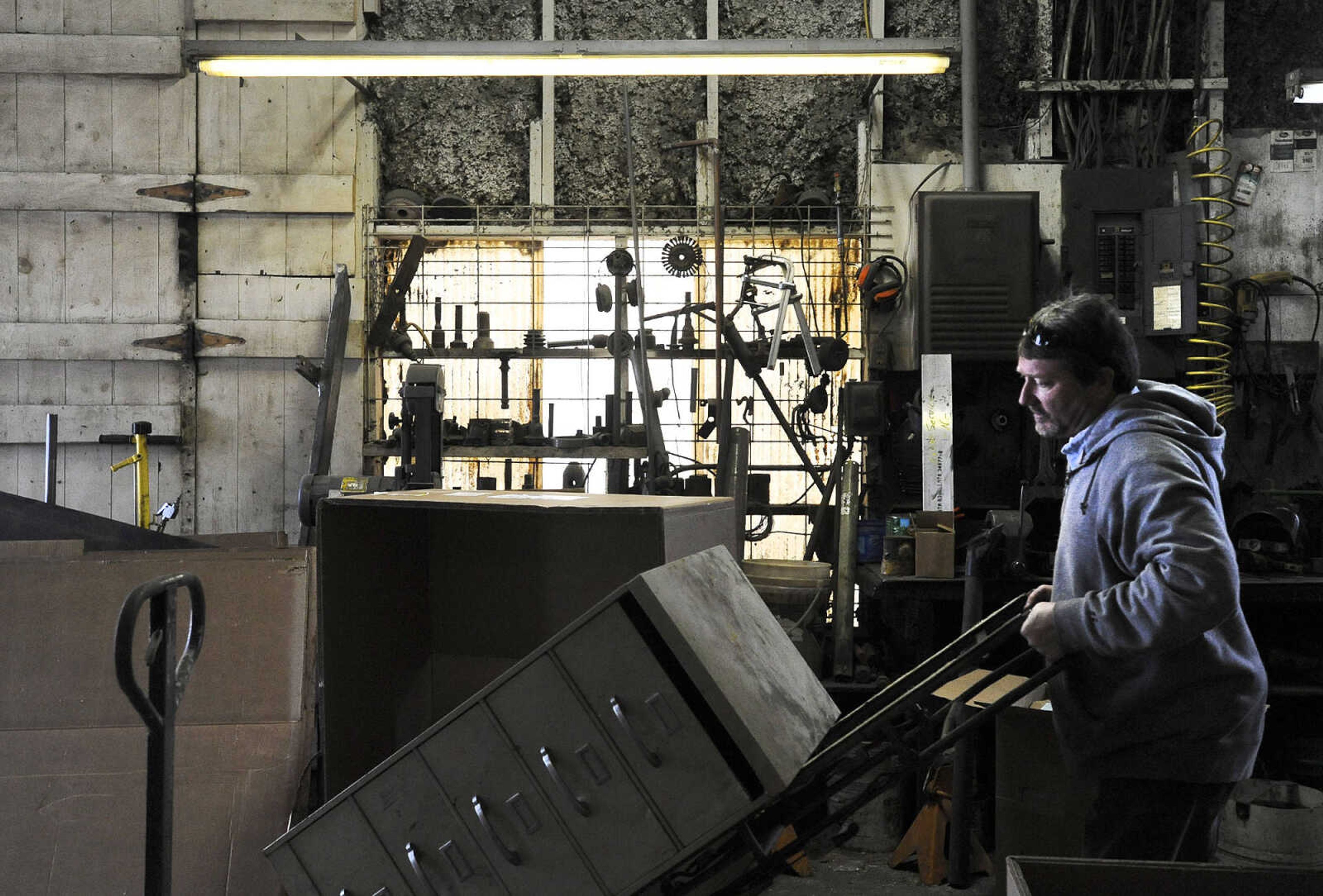 LAURA SIMON ~ lsimon@semissourian.com

John Buerck wheels a storage cabinet out of Ernst Service Station & Machine Shop to take to a higher location, Tuesday, Dec. 29, 2015, in McBride, Missouri.