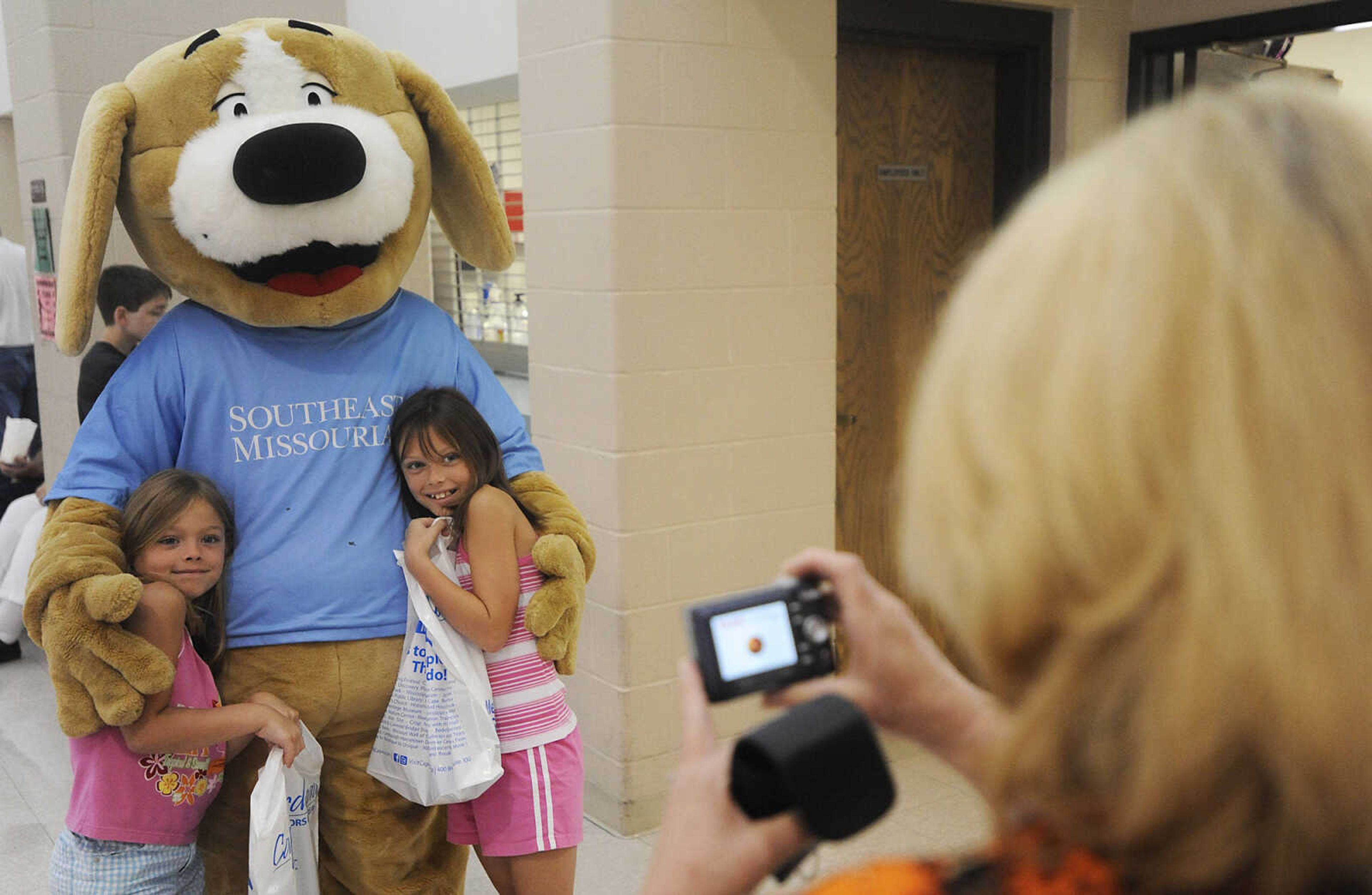 ADAM VOGLER ~ avogler@semissourian.com
Charity, 7, left, and Alexa Jenkins pose for a photo with Tracker during the 11th annual Cape Girardeau Parks and Rec Day Friday, July 13, at the Osage Center.