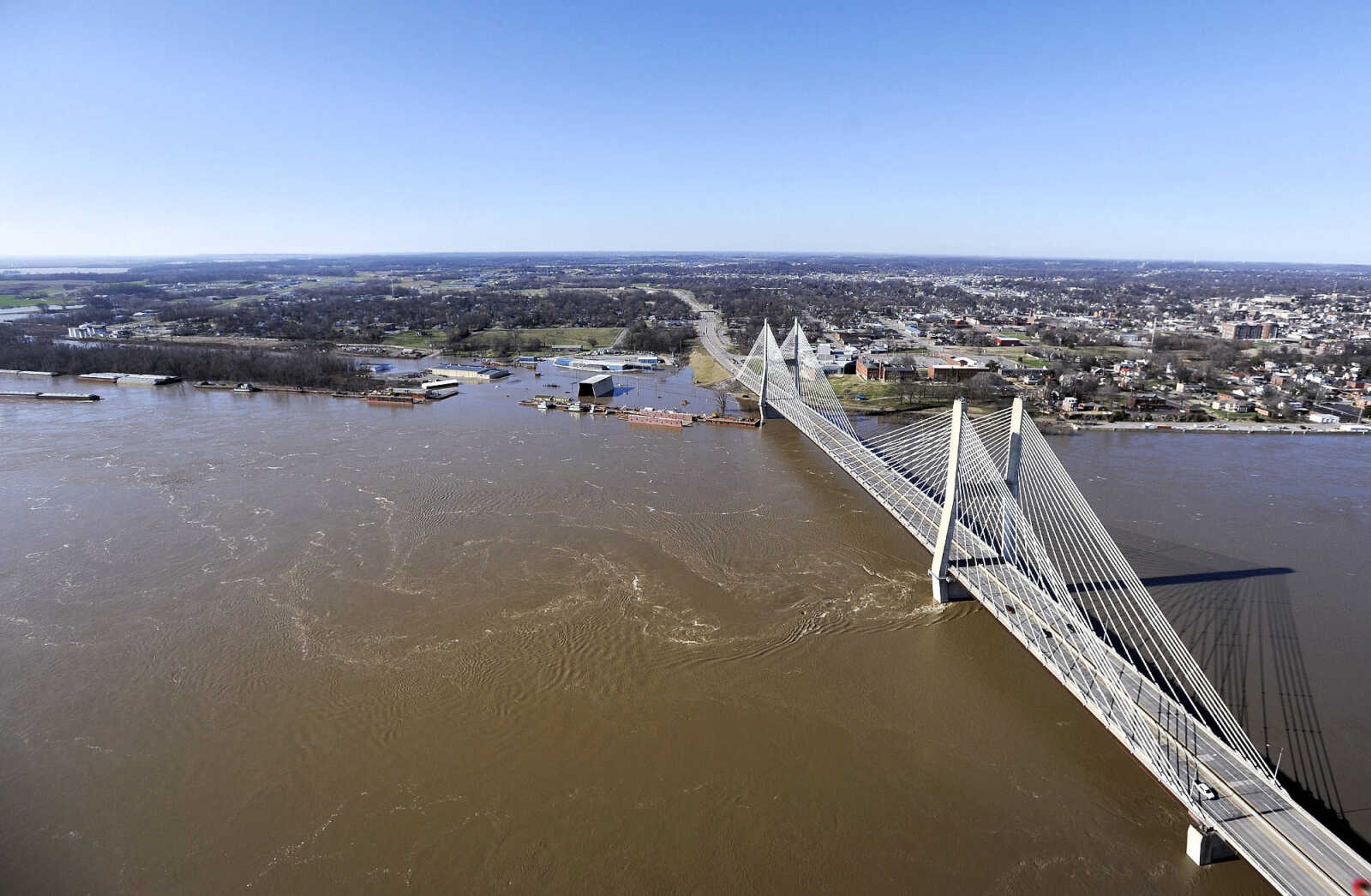 LAURA SIMON ~ lsimon@semissourian.com

The swollen Mississippi River is seen flowing under the Bill Emerson Memorial Bridge in Cape Girardeau, Saturday, Jan. 2, 2016.