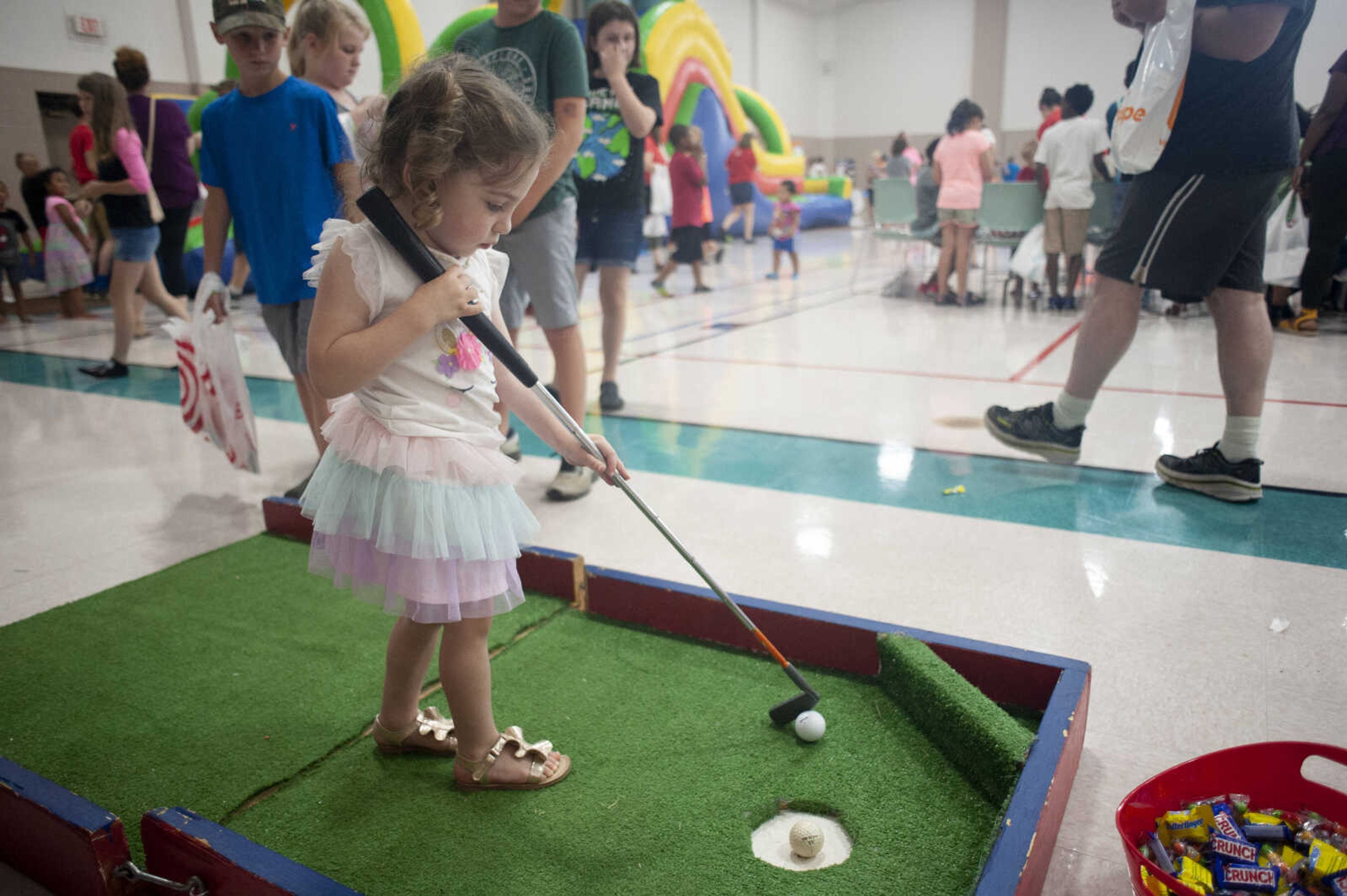 Adelaide Wood, 3, of Jackson, plays golf during the 19th annual Parks and Rec Day on Wednesday, July 10, 2019, at the Osage Centre in Cape Girardeau.