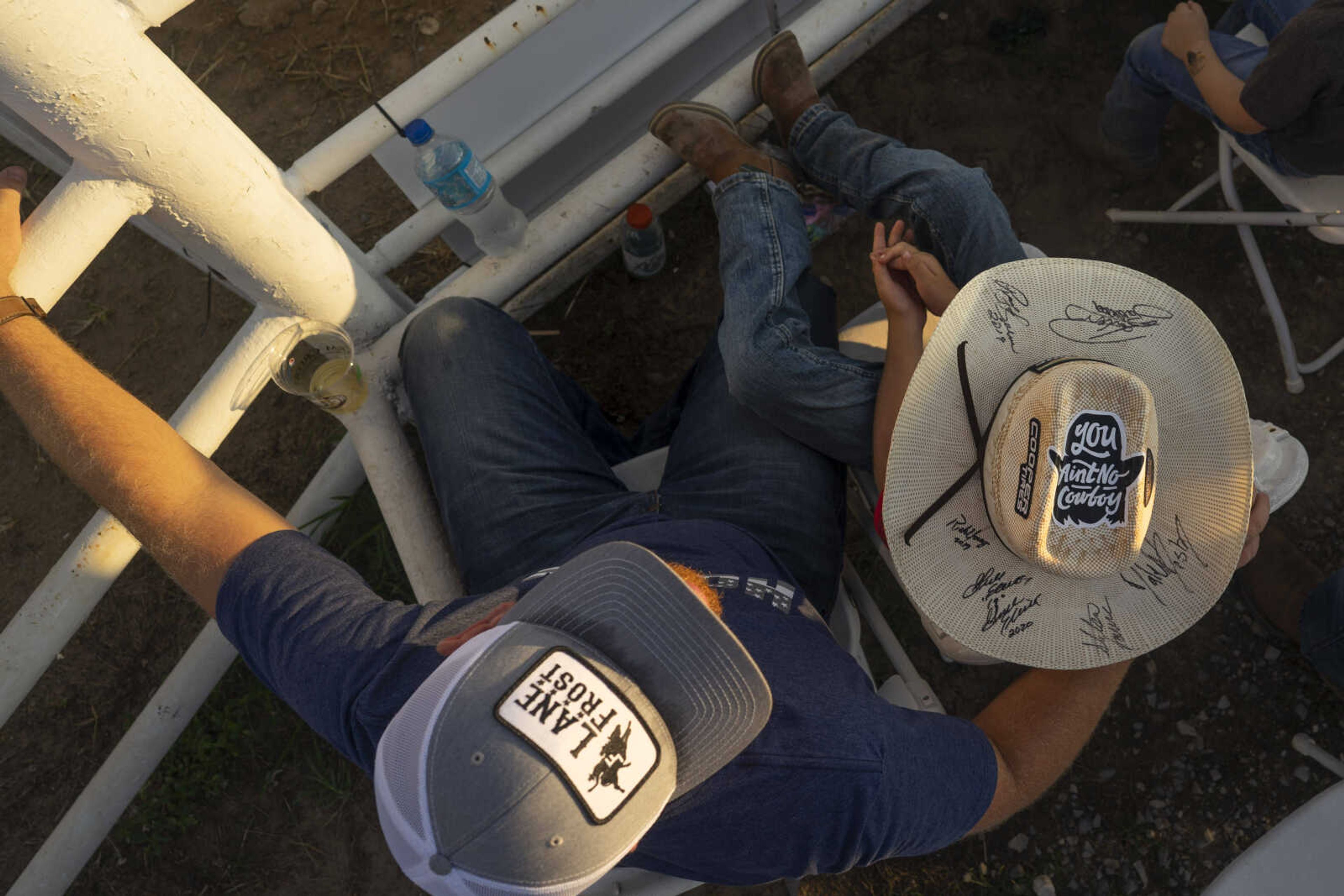 Brandon, left, and Brantly Byrd watch from the front row as riders perform during the first night of the Sikeston Jaycee Bootheel Rodeo on Wednesday, Aug. 11, 2021, in Sikeston, Missouri.