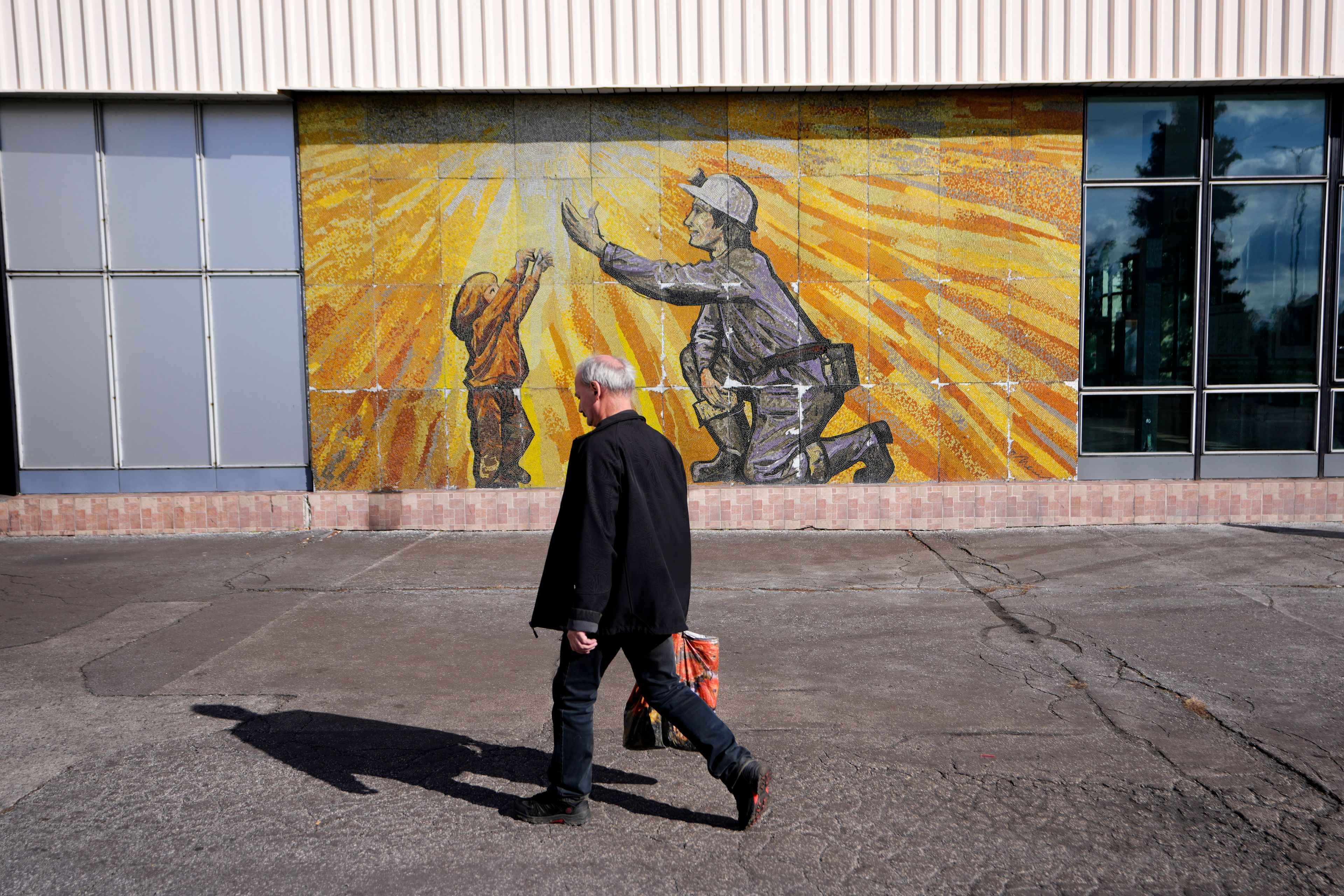 A man walks to the CSM coal mine in Stonava, Czech Republic, Monday, Oct. 14, 2024. (AP Photo/Petr David Josek)