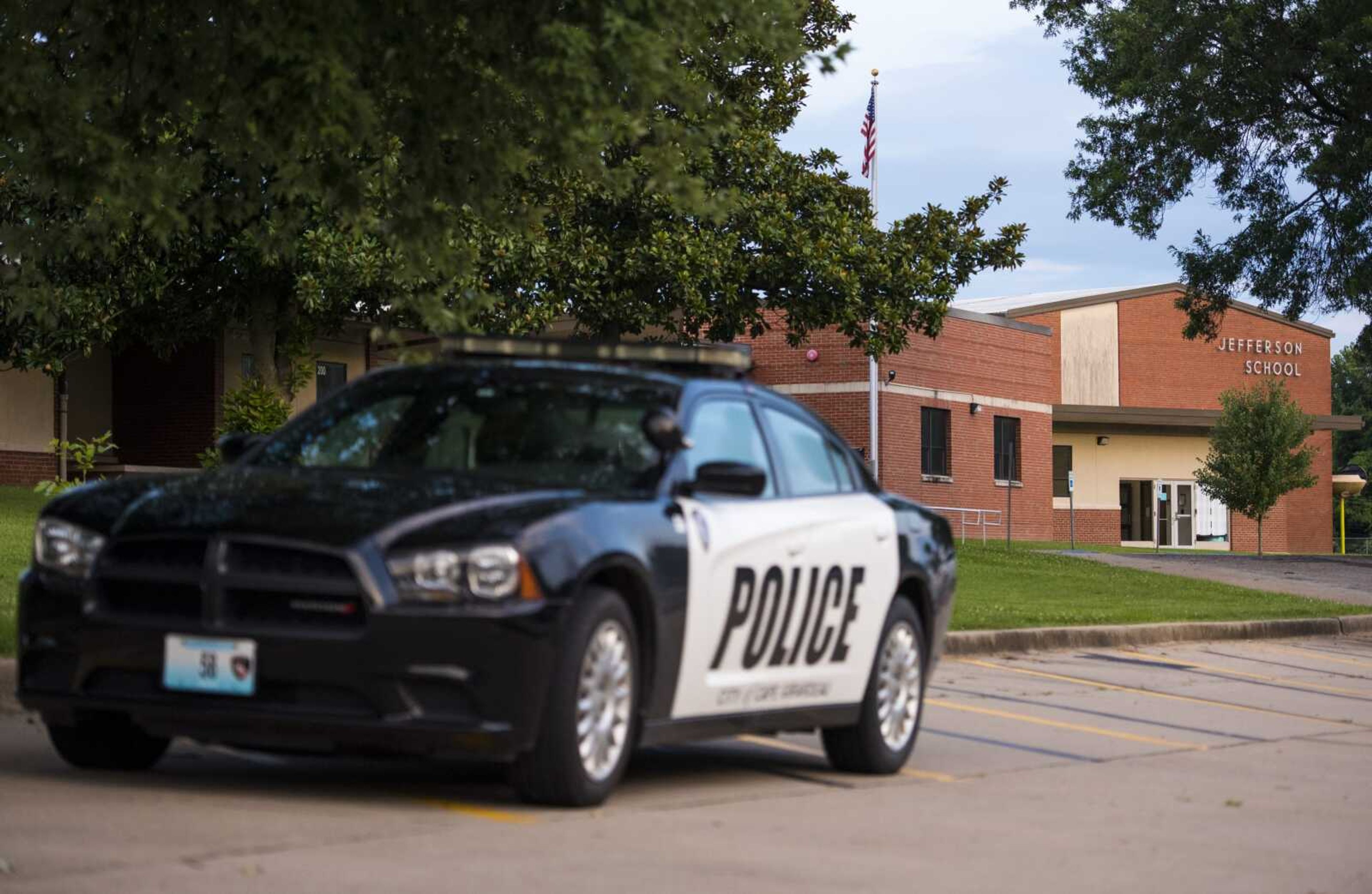 A squad car from the Cape Girardeau Police Department sits in the parking lot at Jefferson Elementary School as officers investigate the scene of a shooting Monday in Cape Girardeau.