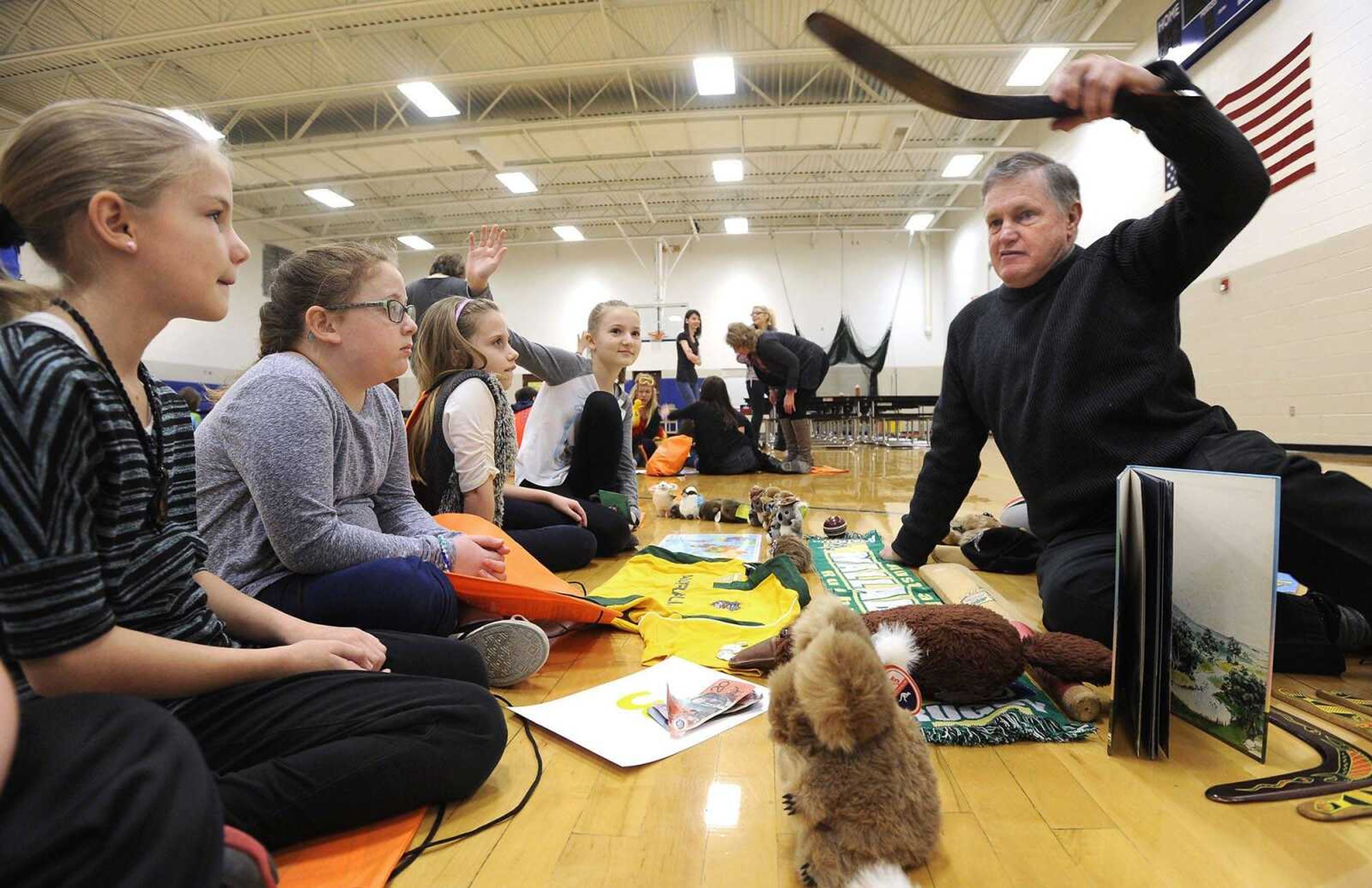 Peter Gordon, a native of Australia, explains the use of a boomerang Wednesday to his young listeners, from left, Zaylie Diebold, Ava Knotts, Bailey Hahn and Kylie Ingram at Oran Elementary School in Oran, Missouri.