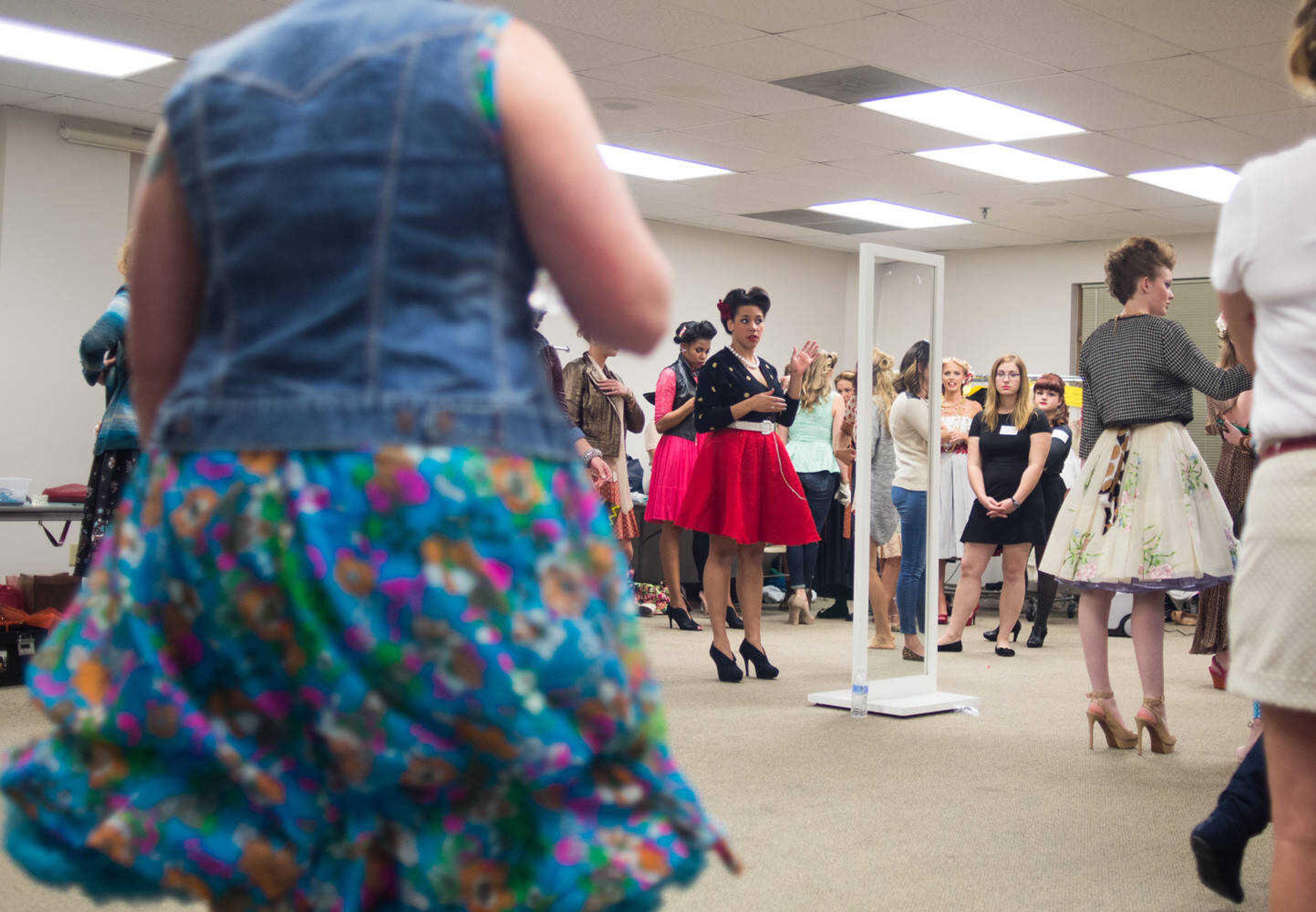 AARON EISENHAUER ~ photos@semissourian.com
Models prepare backstage before taking the runway for the fifth annual VintageNOW fashion show, a fundraiser for Safe House for Women, at the Osage Centre on Friday, October 17, 2014.